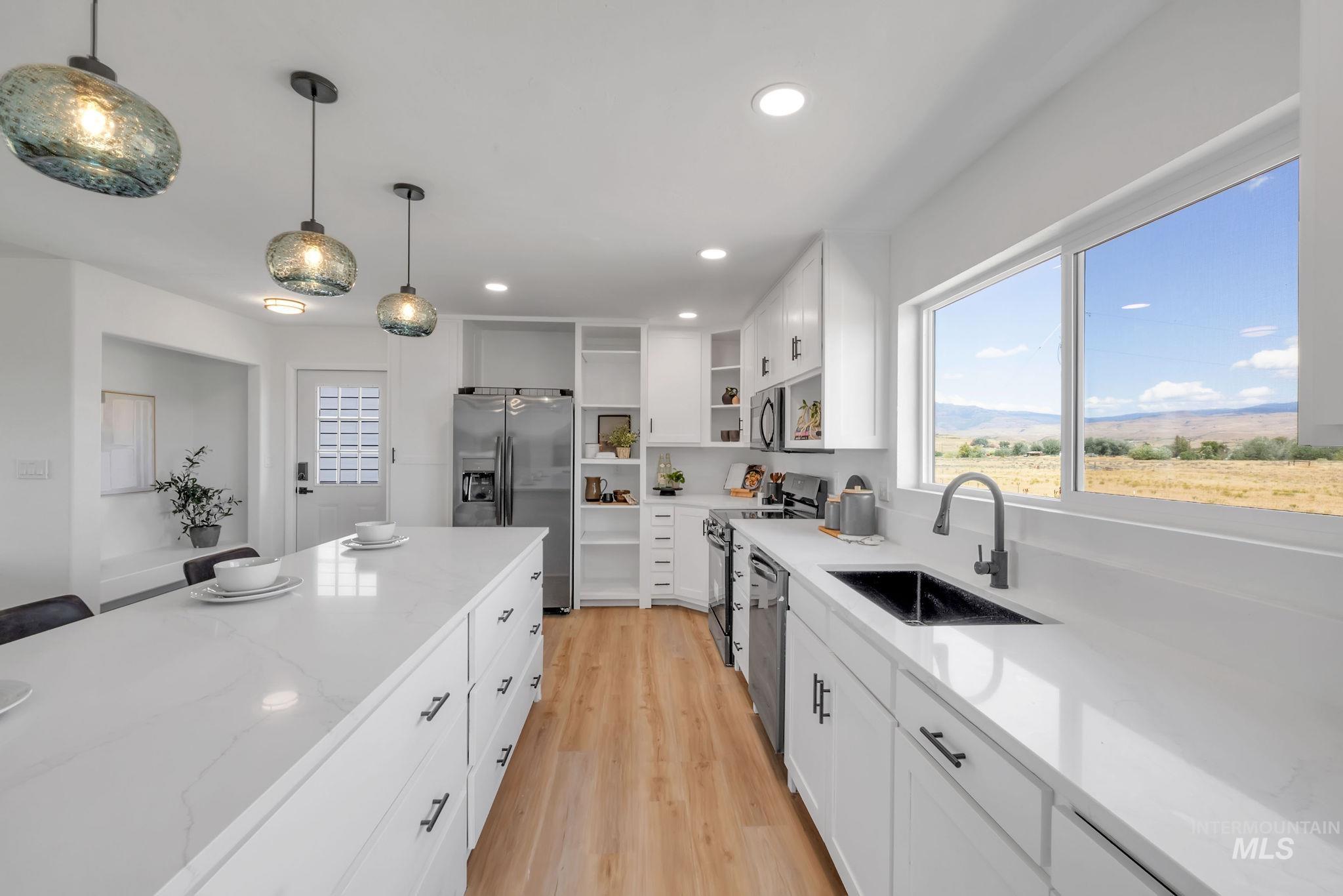 Kitchen with open shelves, recessed lighting, appliances with stainless steel finishes, light wood-type flooring, and light stone counters