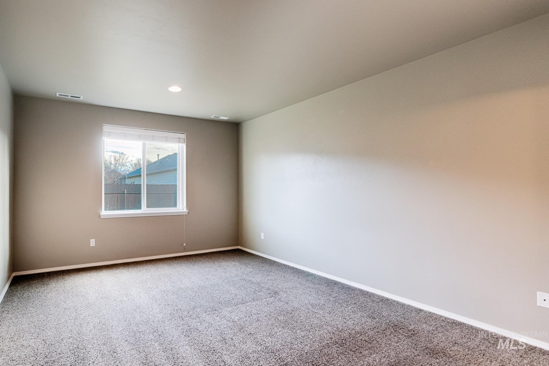 Carpeted empty room featuring baseboards and recessed lighting