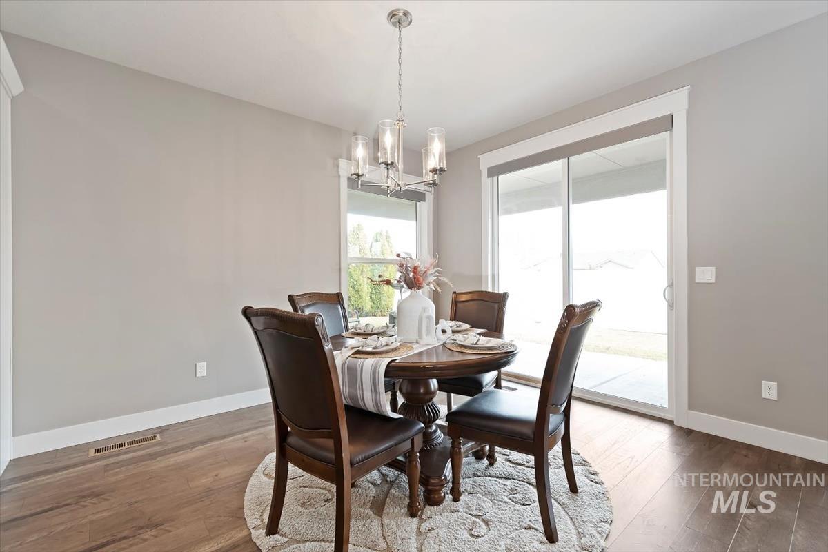 Dining room featuring wood-type flooring and a chandelier