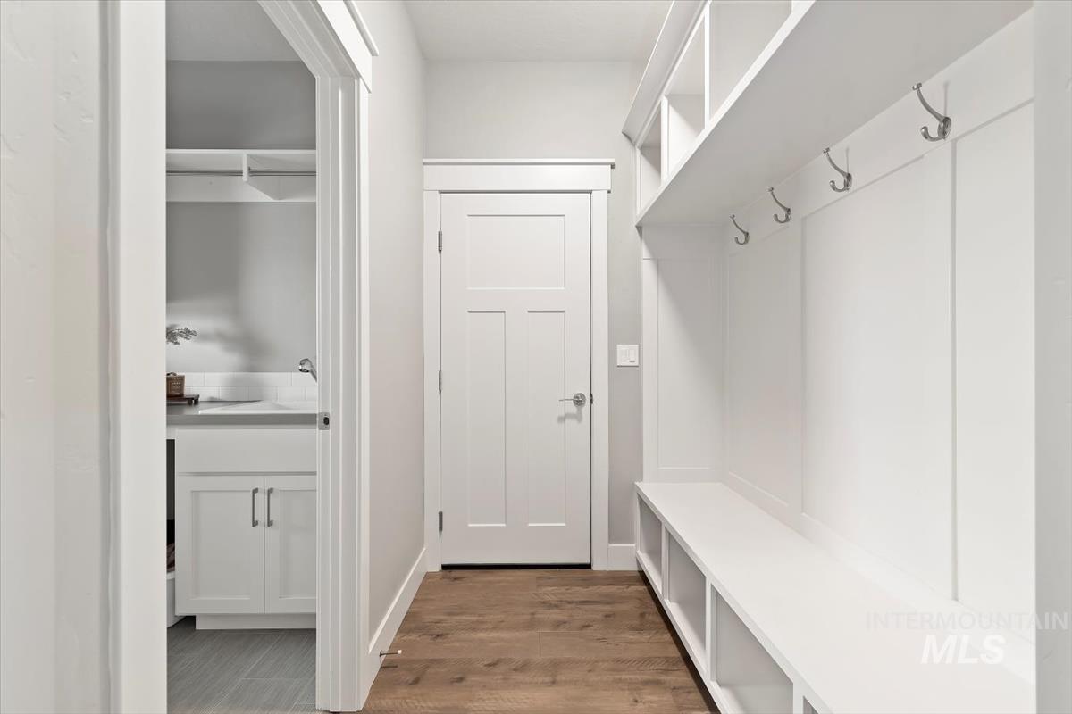 Mudroom with light wood-style floors and baseboards