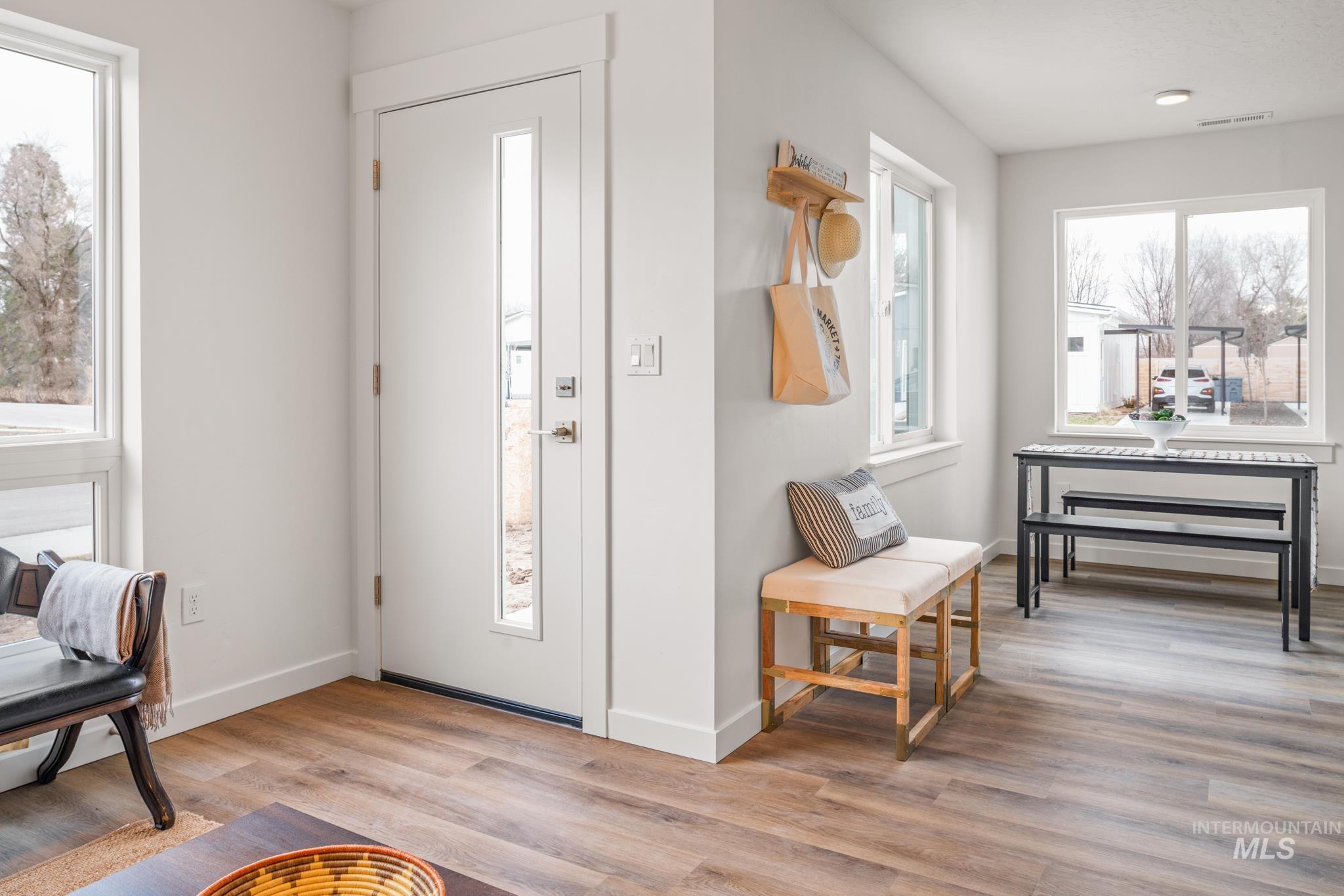 Foyer entrance with baseboards and light wood finished floors
