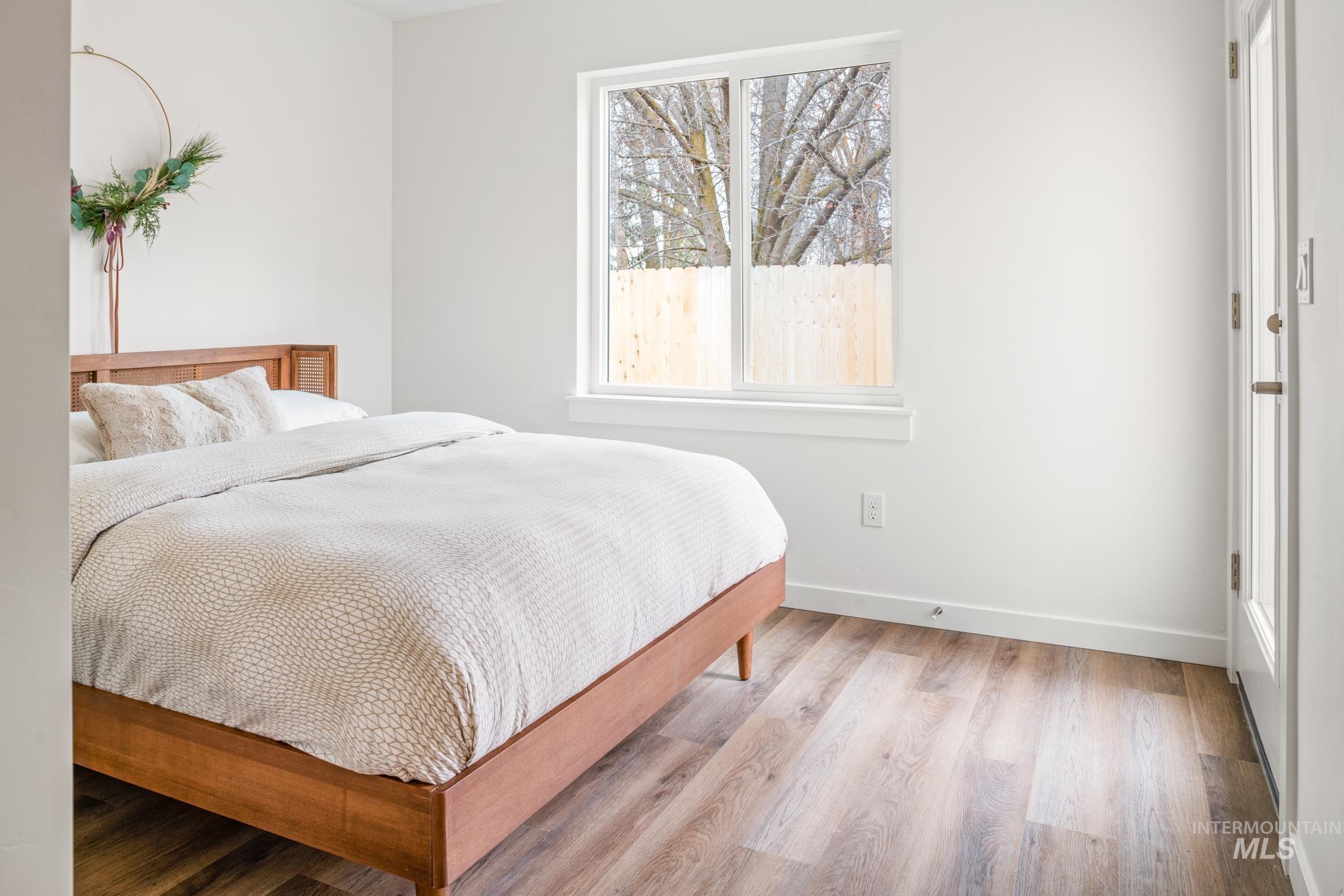 Bedroom featuring light wood-style flooring and baseboards