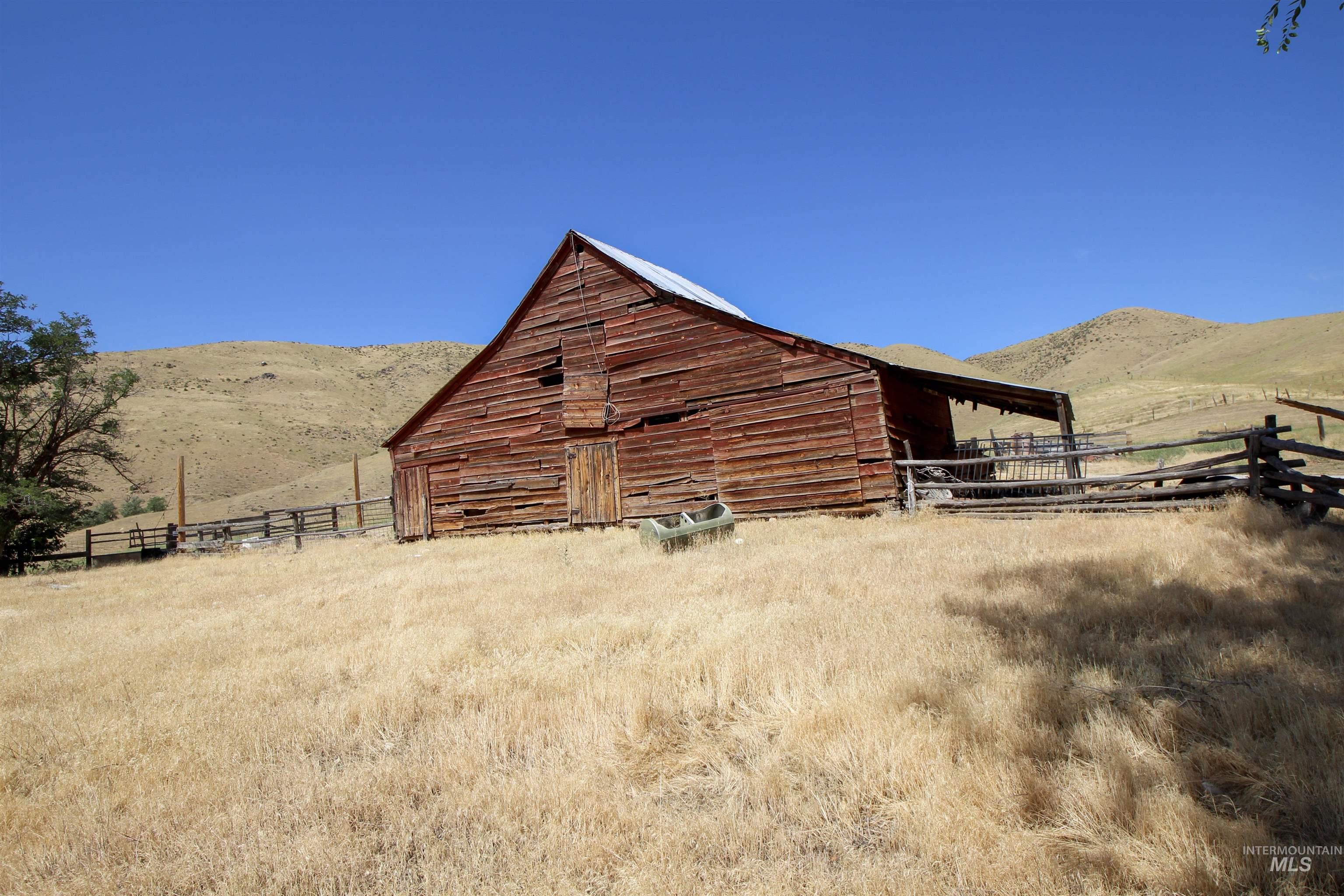 View of barn featuring a mountain view and a view of rural / pastoral area
