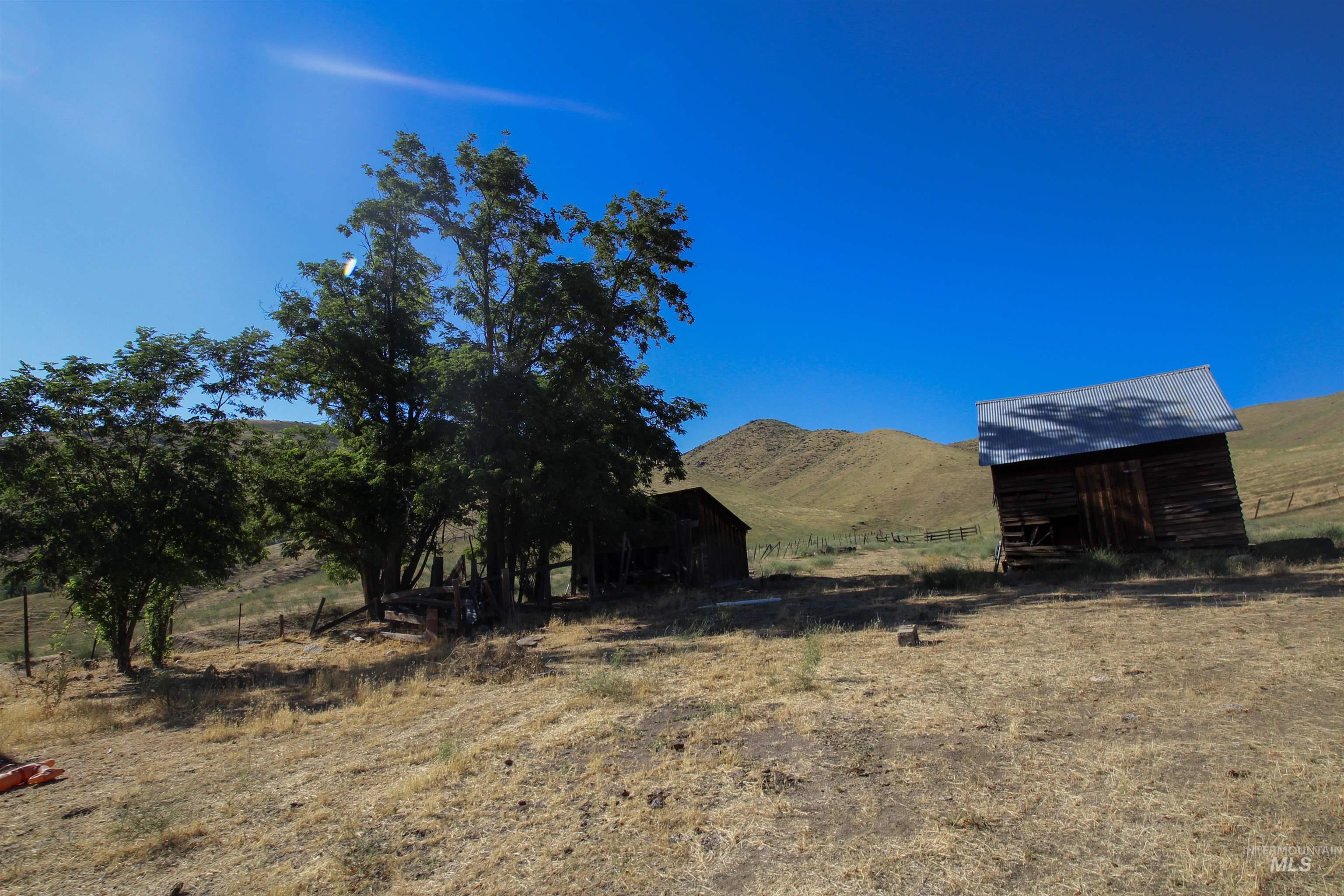 View of yard featuring a mountain view, a view of rural / pastoral area, and an outdoor structure
