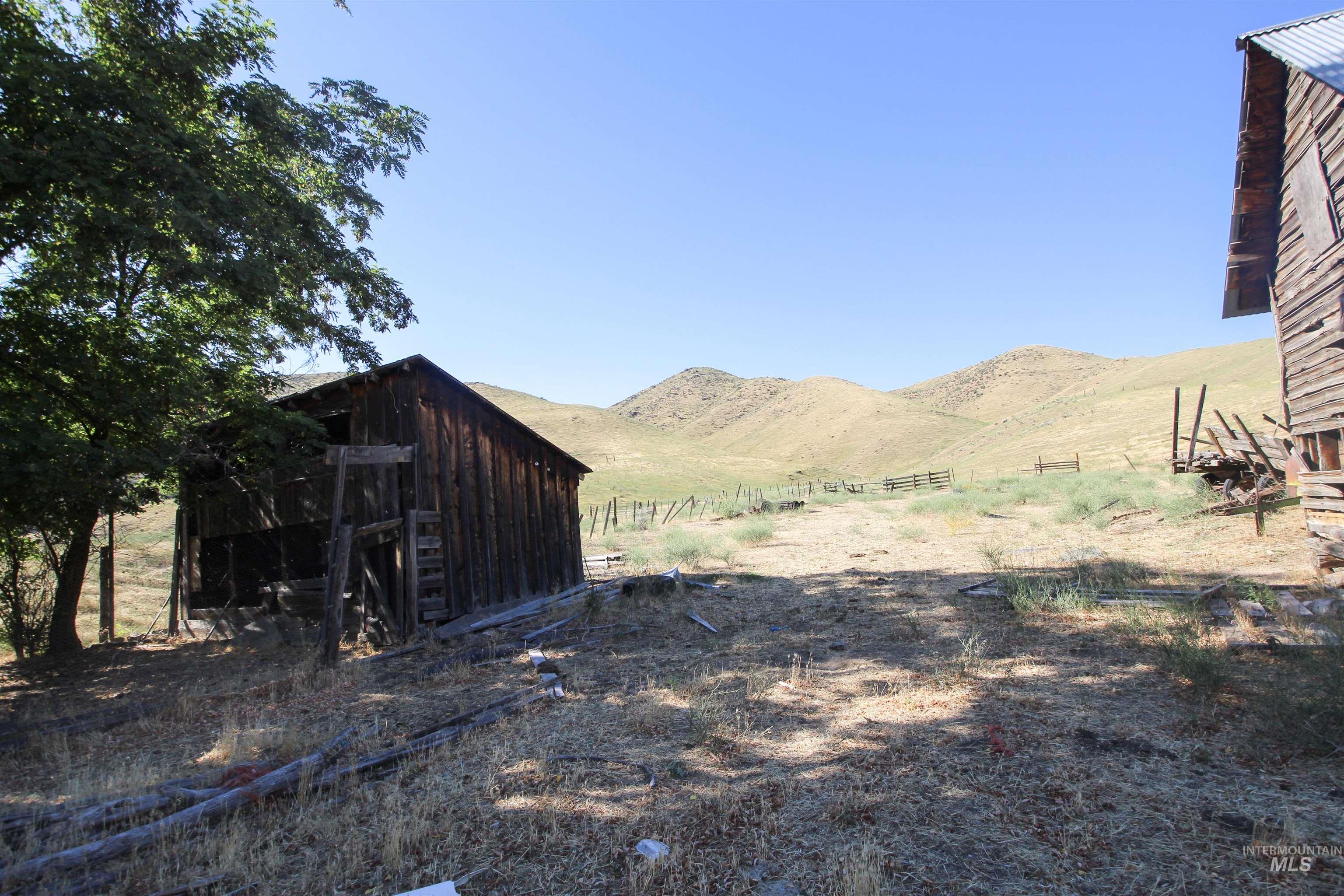 View of yard featuring a mountain view, a view of rural / pastoral area, and an outbuilding