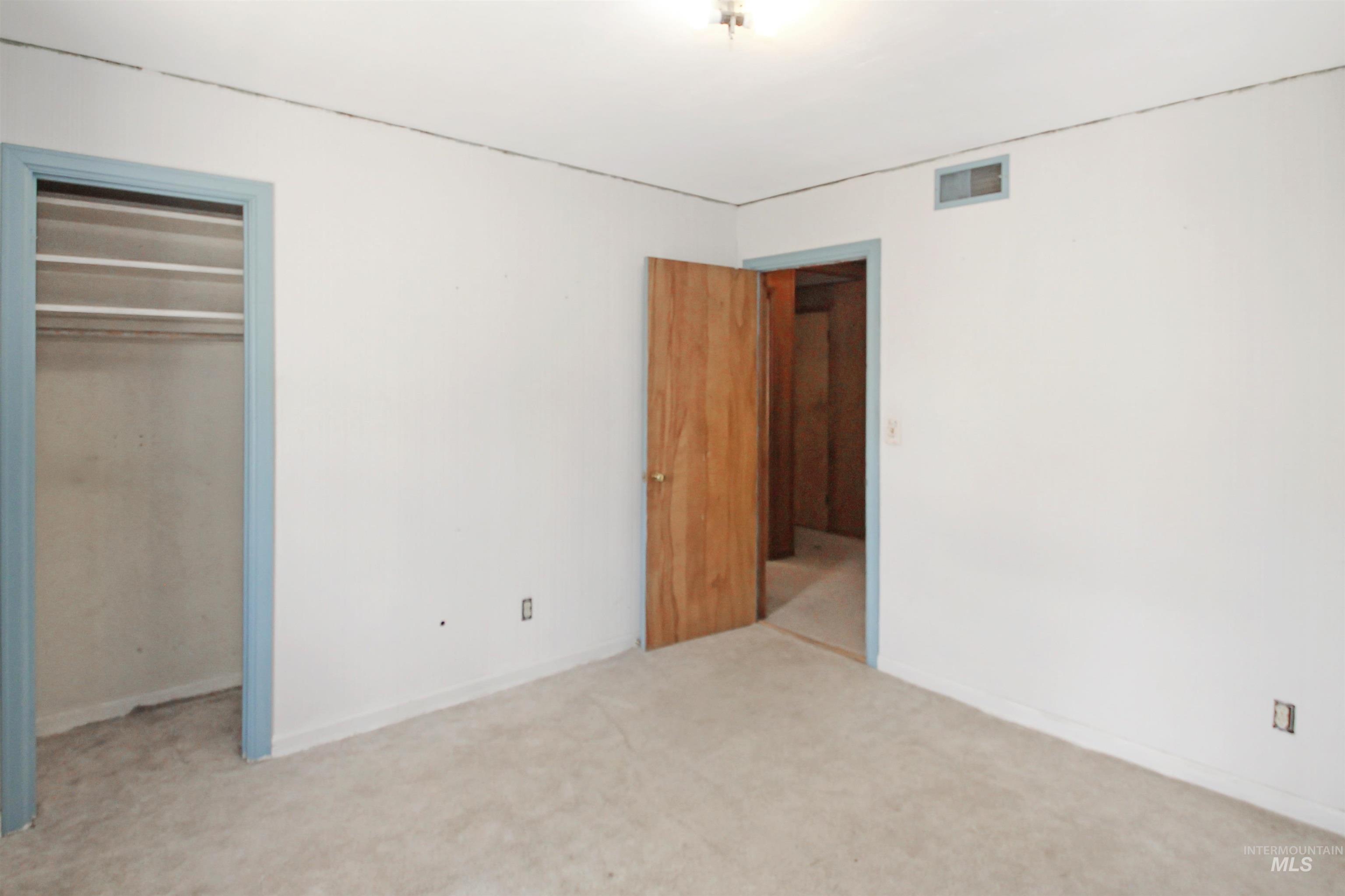 Unfurnished bedroom with a closet and carpet flooring