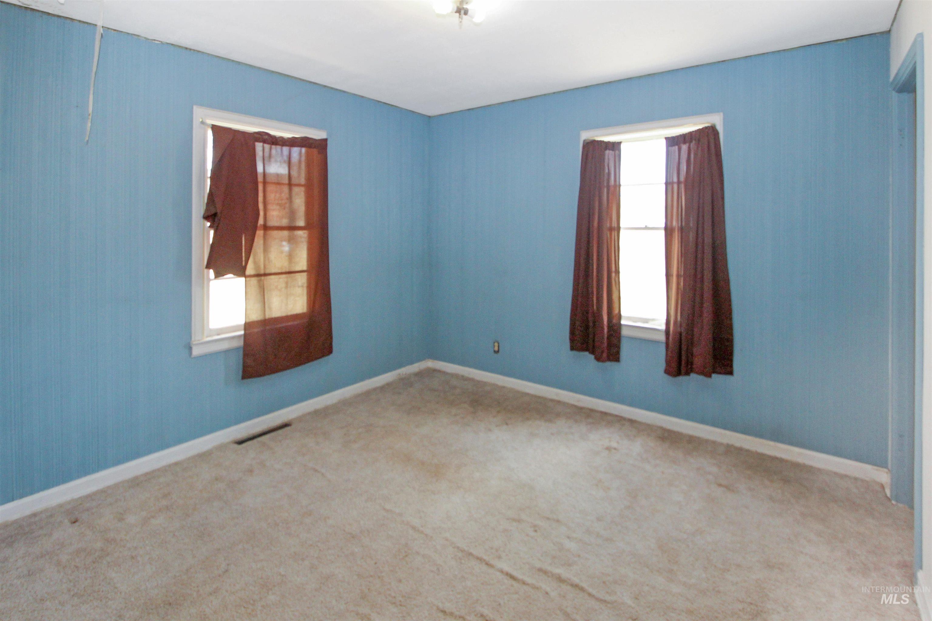 Unfurnished room featuring carpet floors and baseboards