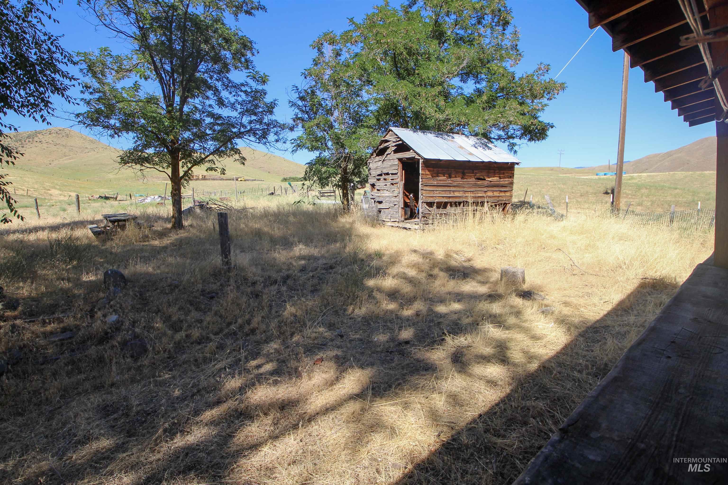 View of yard with a mountain view, a view of countryside, and an outdoor structure