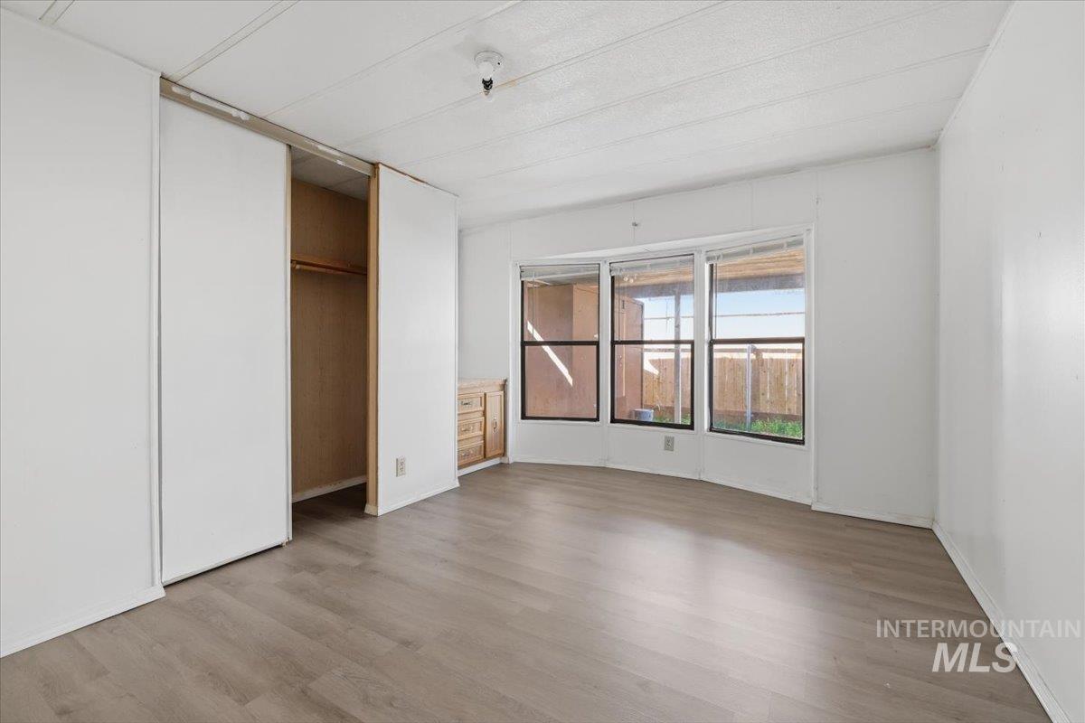 Unfurnished bedroom with a closet and light wood finished floors