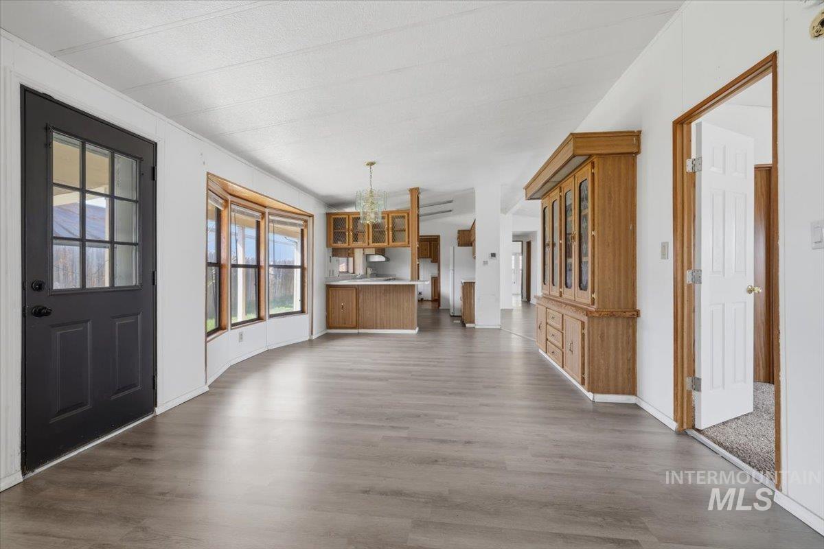 Entrance foyer featuring dark wood finished floors and hanging lights