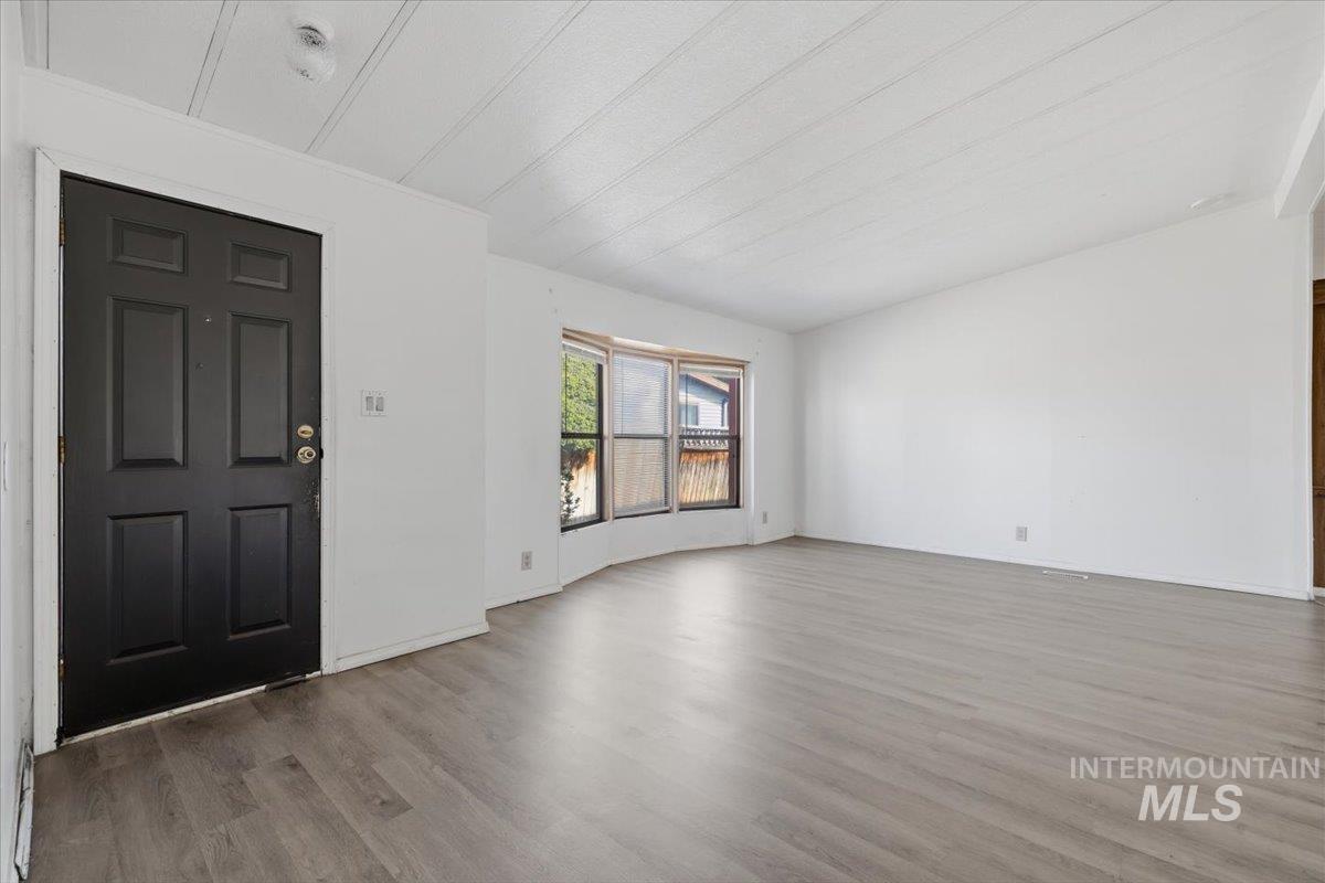 Entryway featuring light wood finished floors and lofted ceiling