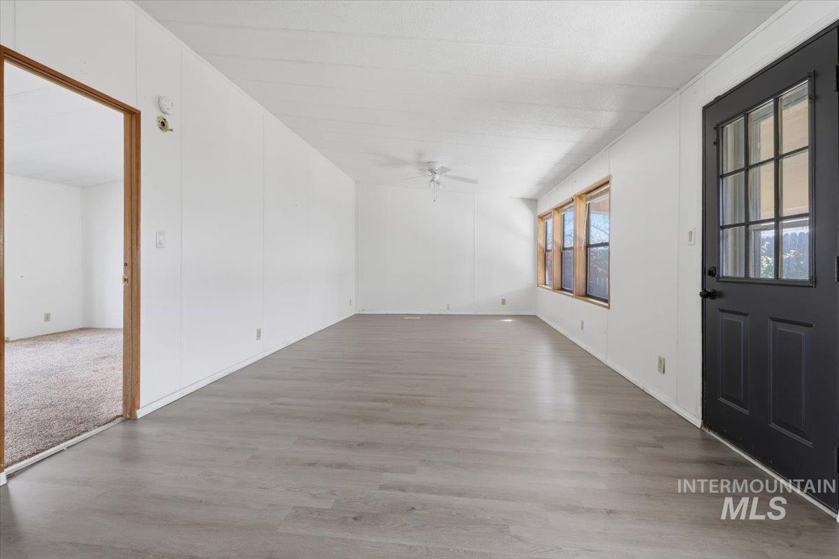 Entrance foyer featuring light wood finished floors and ceiling fan