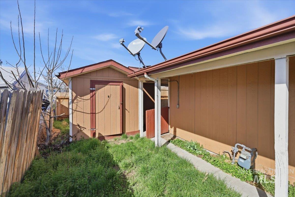 View of side of property featuring a storage unit
