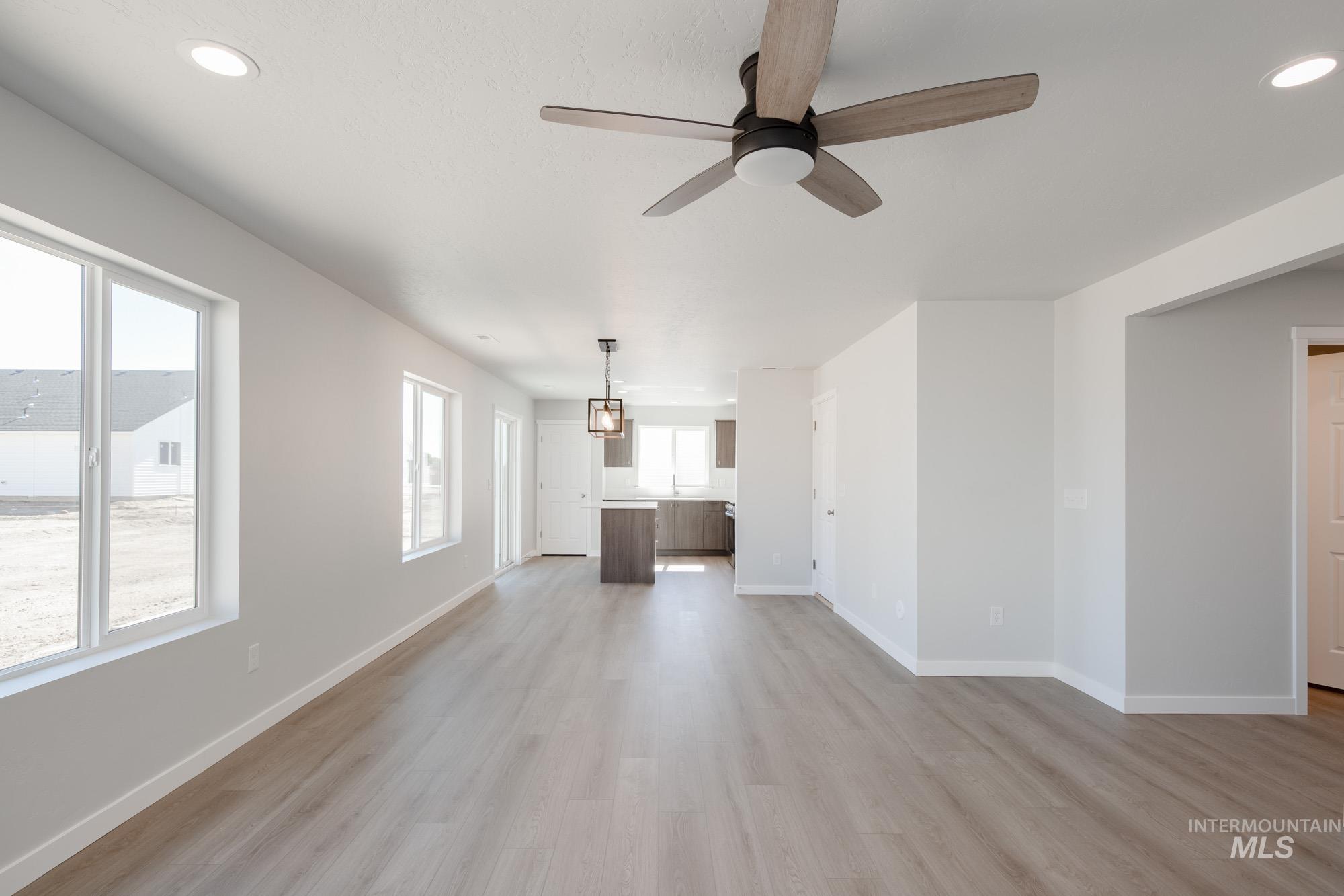 Unfurnished living room featuring recessed lighting, light wood-type flooring, and ceiling fan