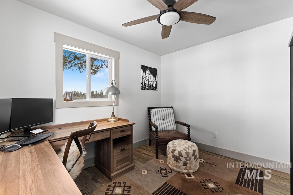 Office featuring dark wood-style flooring and ceiling fan