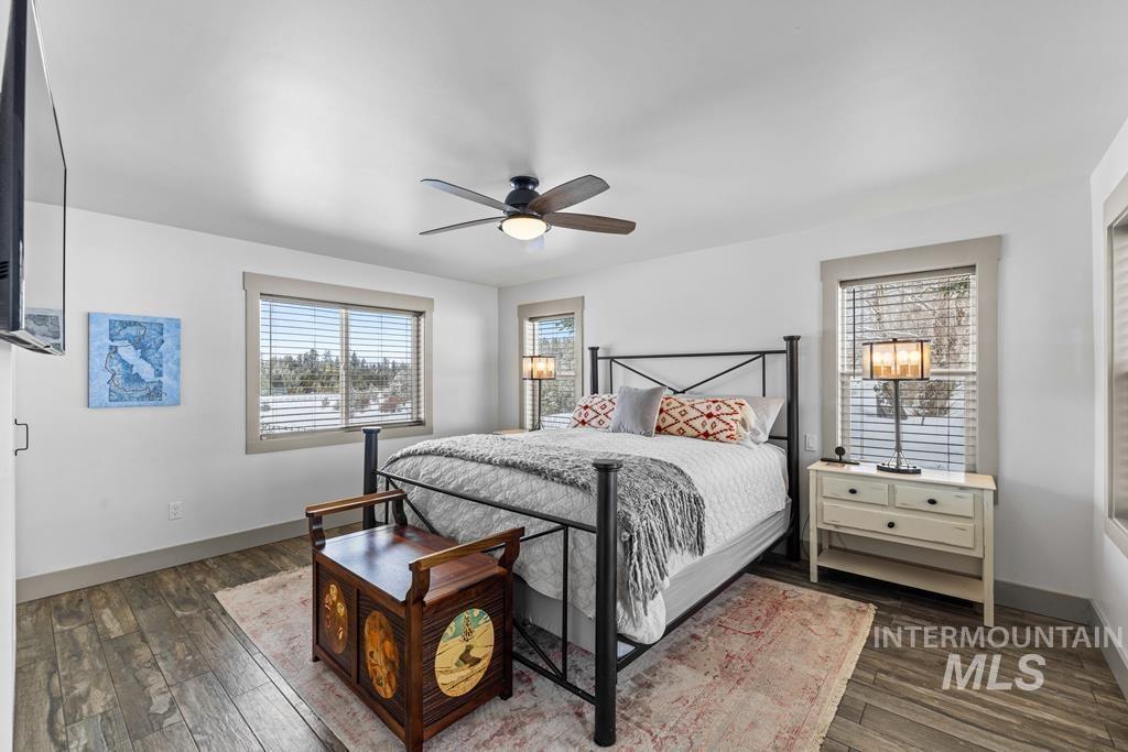 Bedroom featuring a ceiling fan and dark wood-type flooring