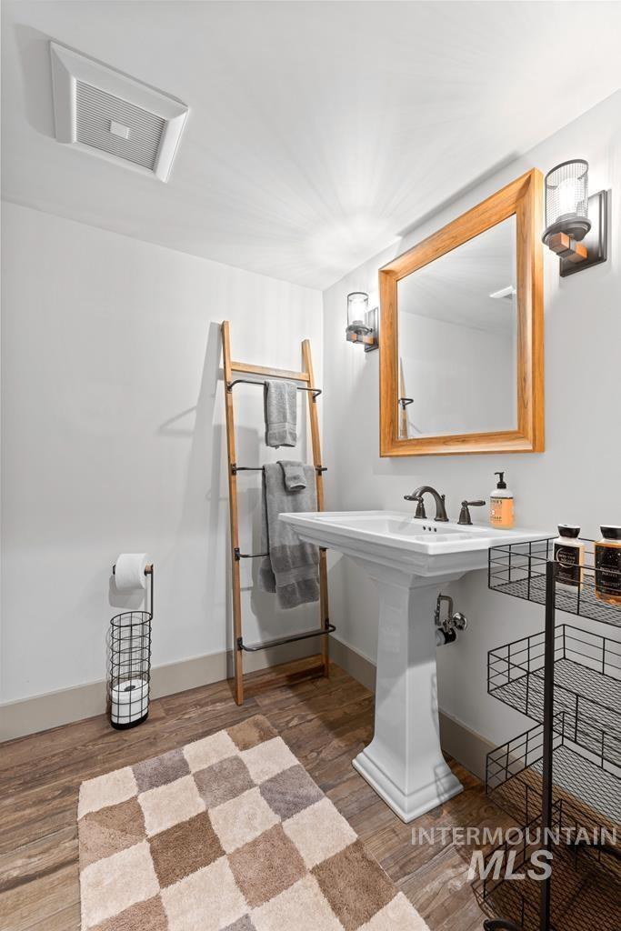 Bathroom featuring light wood finished floors and baseboards