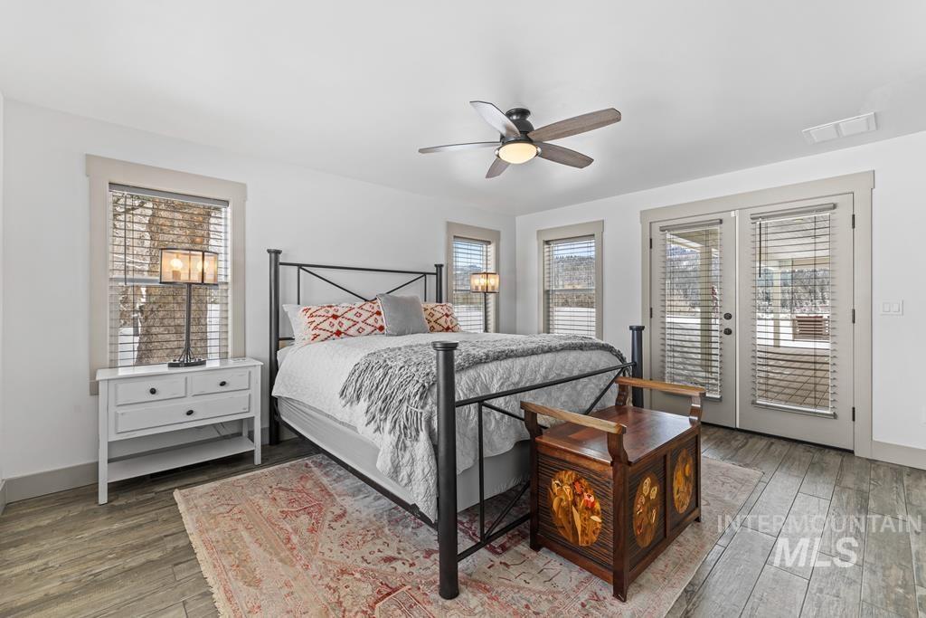 Bedroom featuring multiple windows, ceiling fan, access to outside, and french doors