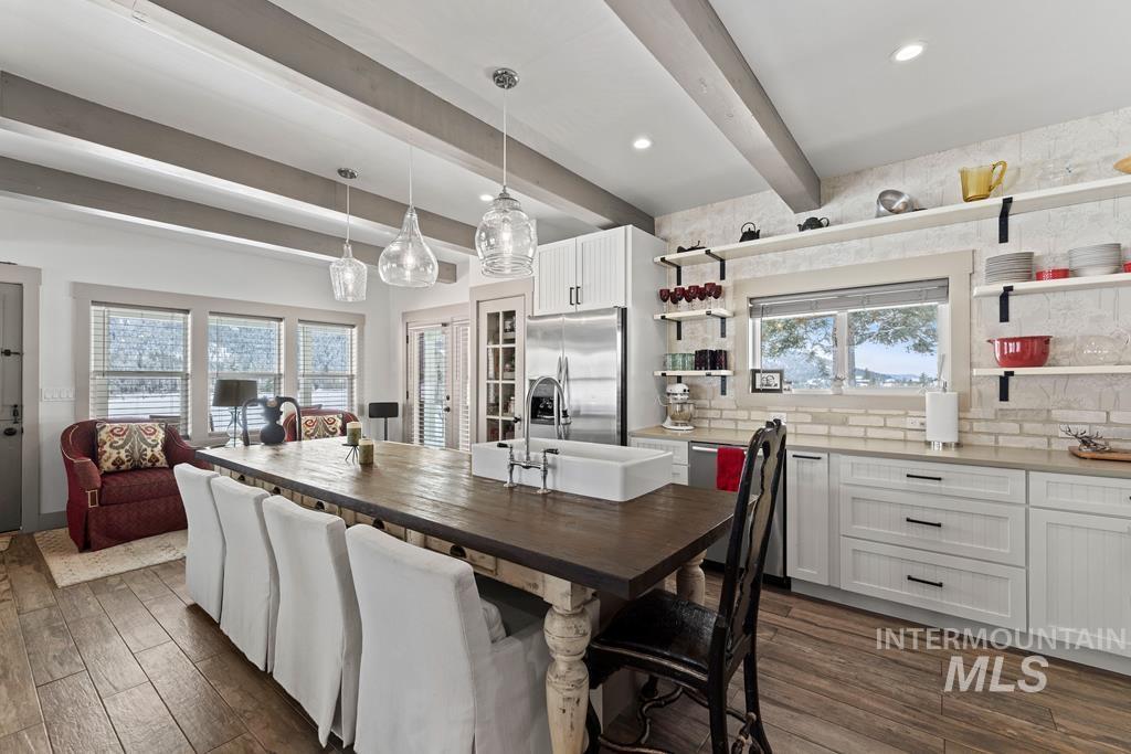 Dining room featuring beamed ceiling, dark wood-style flooring, and recessed lighting