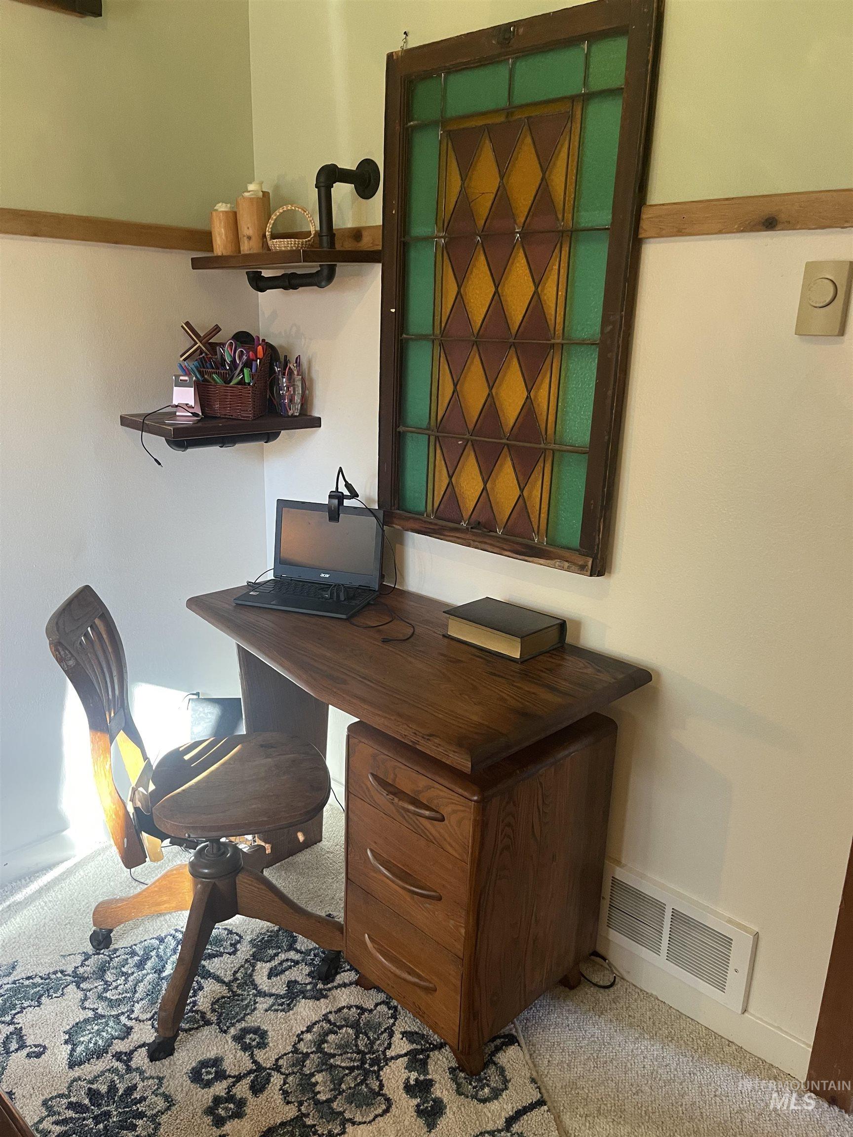Home office featuring light carpet and baseboards