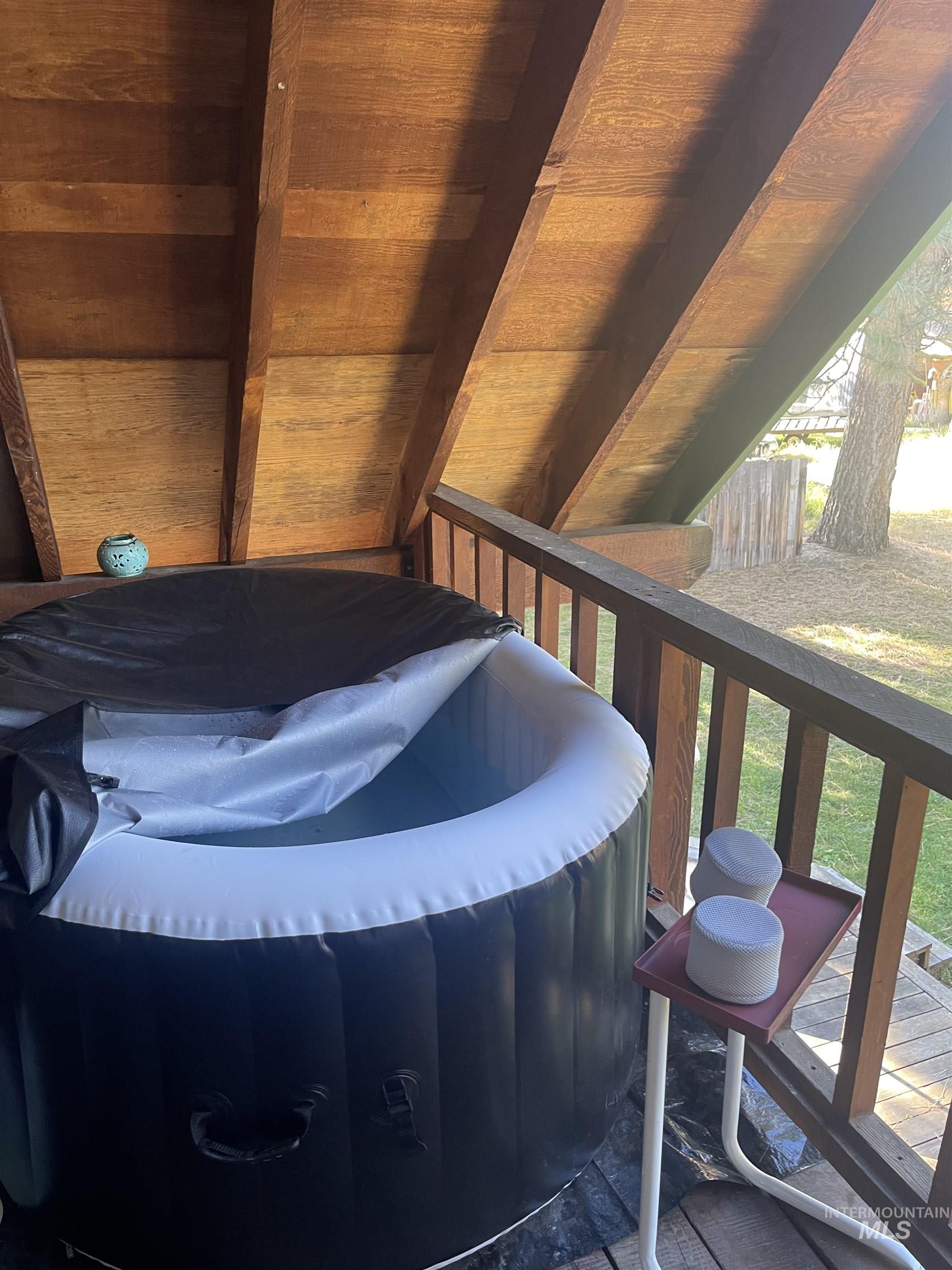 Wooden terrace featuring a hot tub