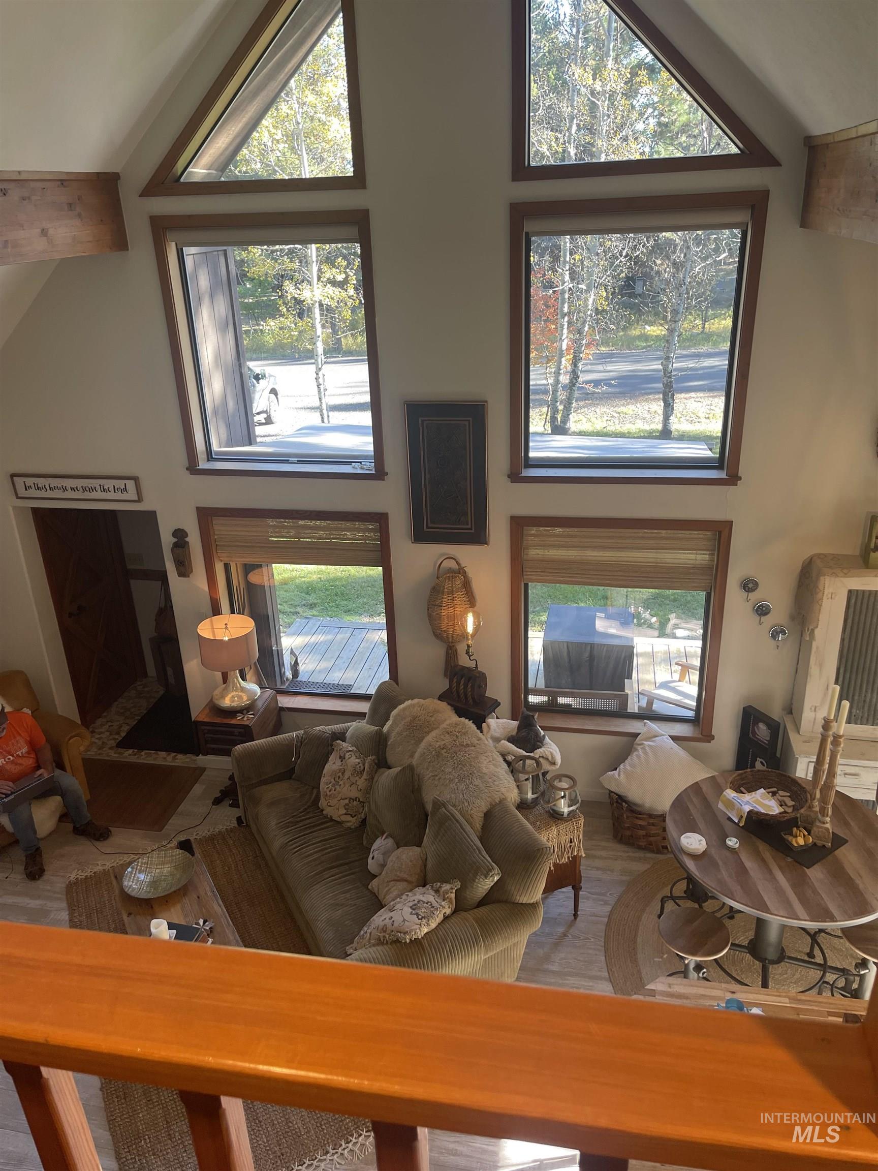 Living room featuring high vaulted ceiling and plenty of natural light