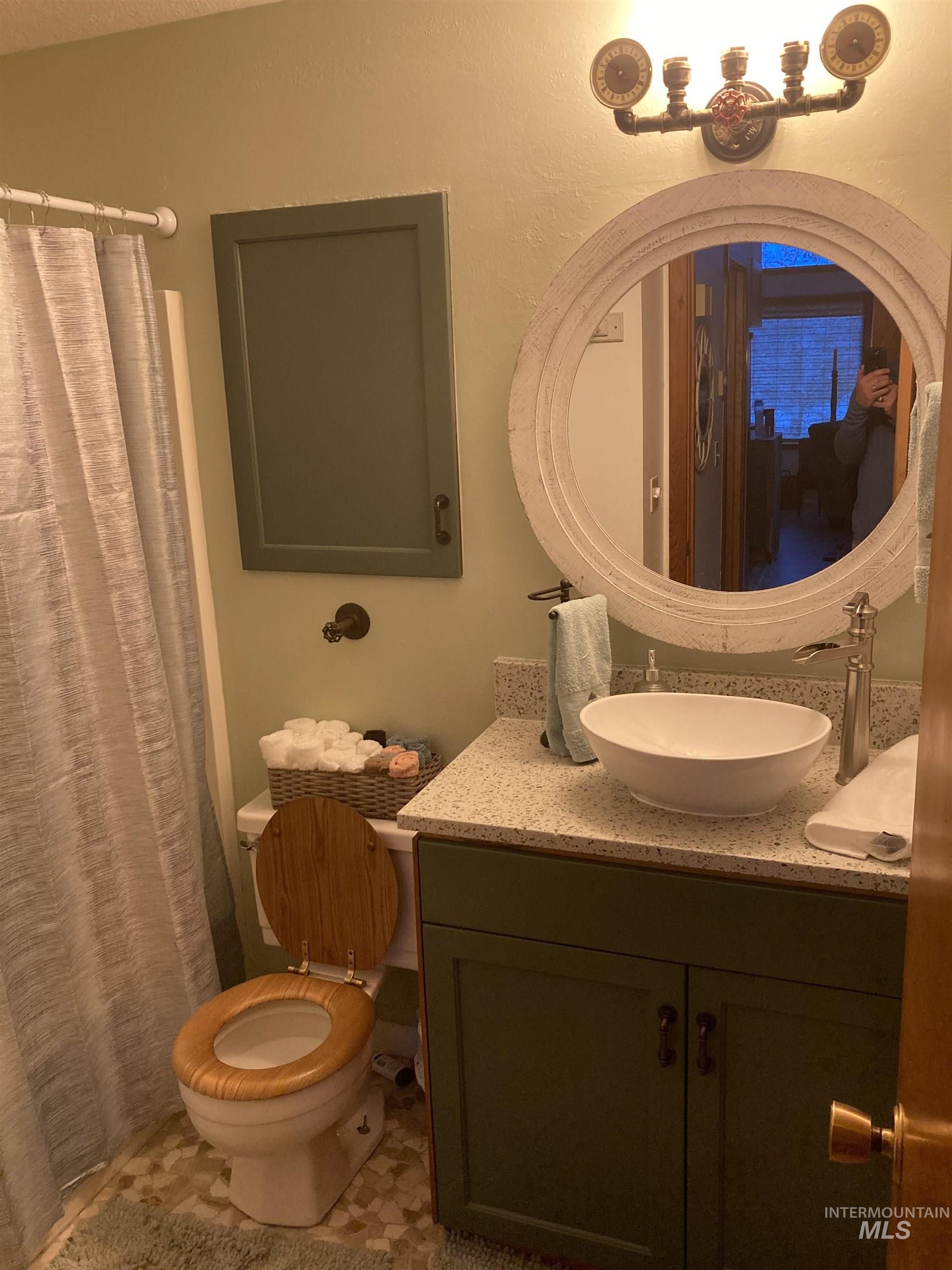 Full bath featuring vanity and a shower with shower curtain