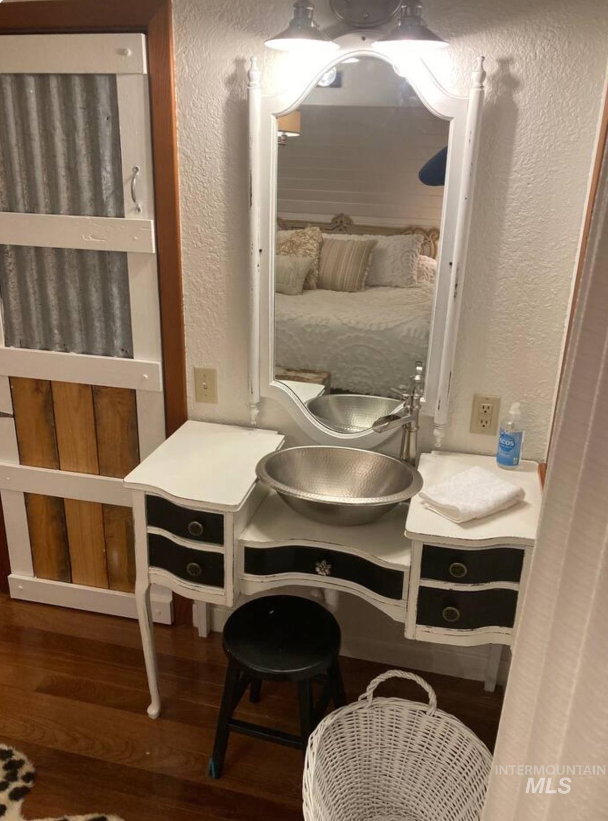 Detailed view of a textured wall and wood finished floors