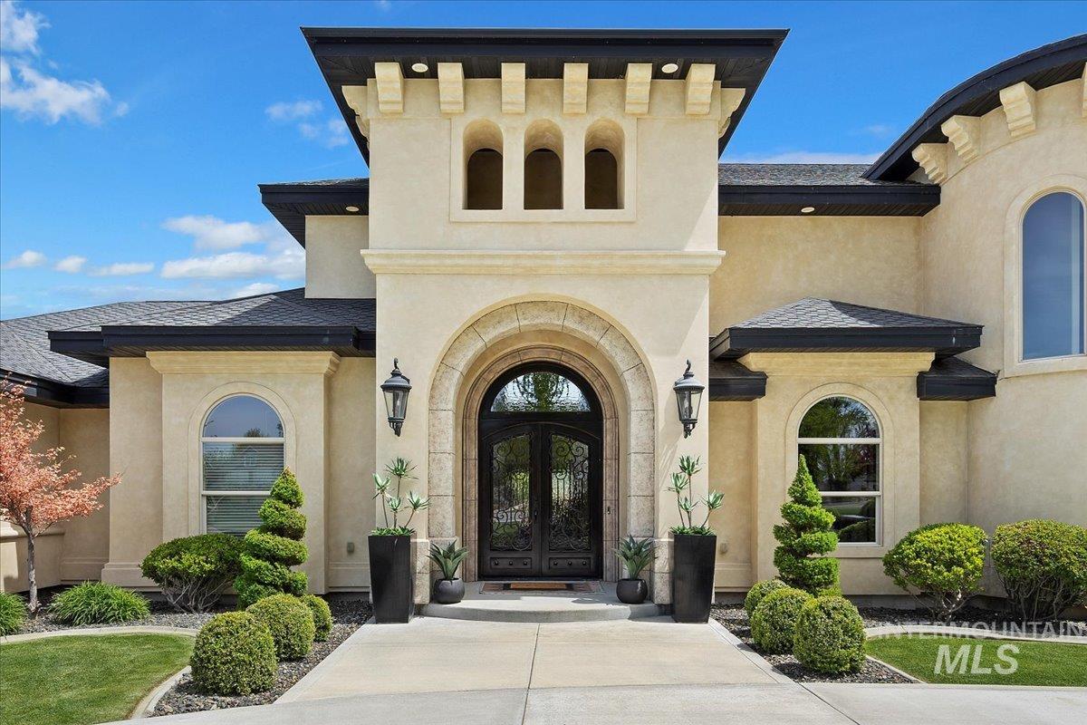 Property entrance with french doors and stucco siding