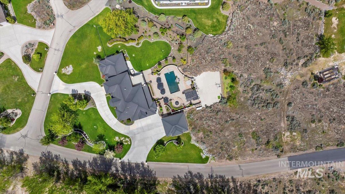 Aerial view of property and surrounding area with a pool