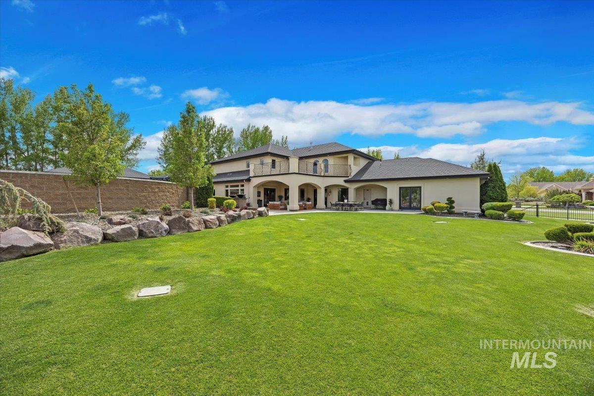 Back of property with stucco siding and a patio area