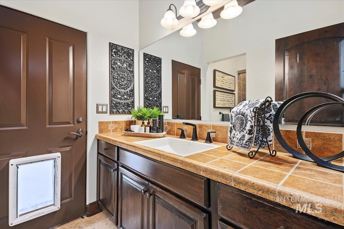 Bathroom featuring vanity and a chandelier