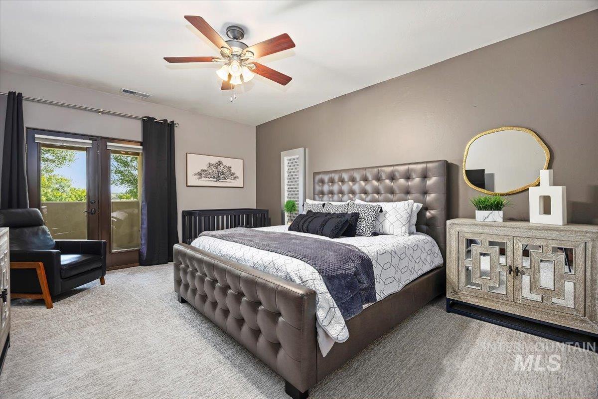 Carpeted bedroom with access to exterior and ceiling fan