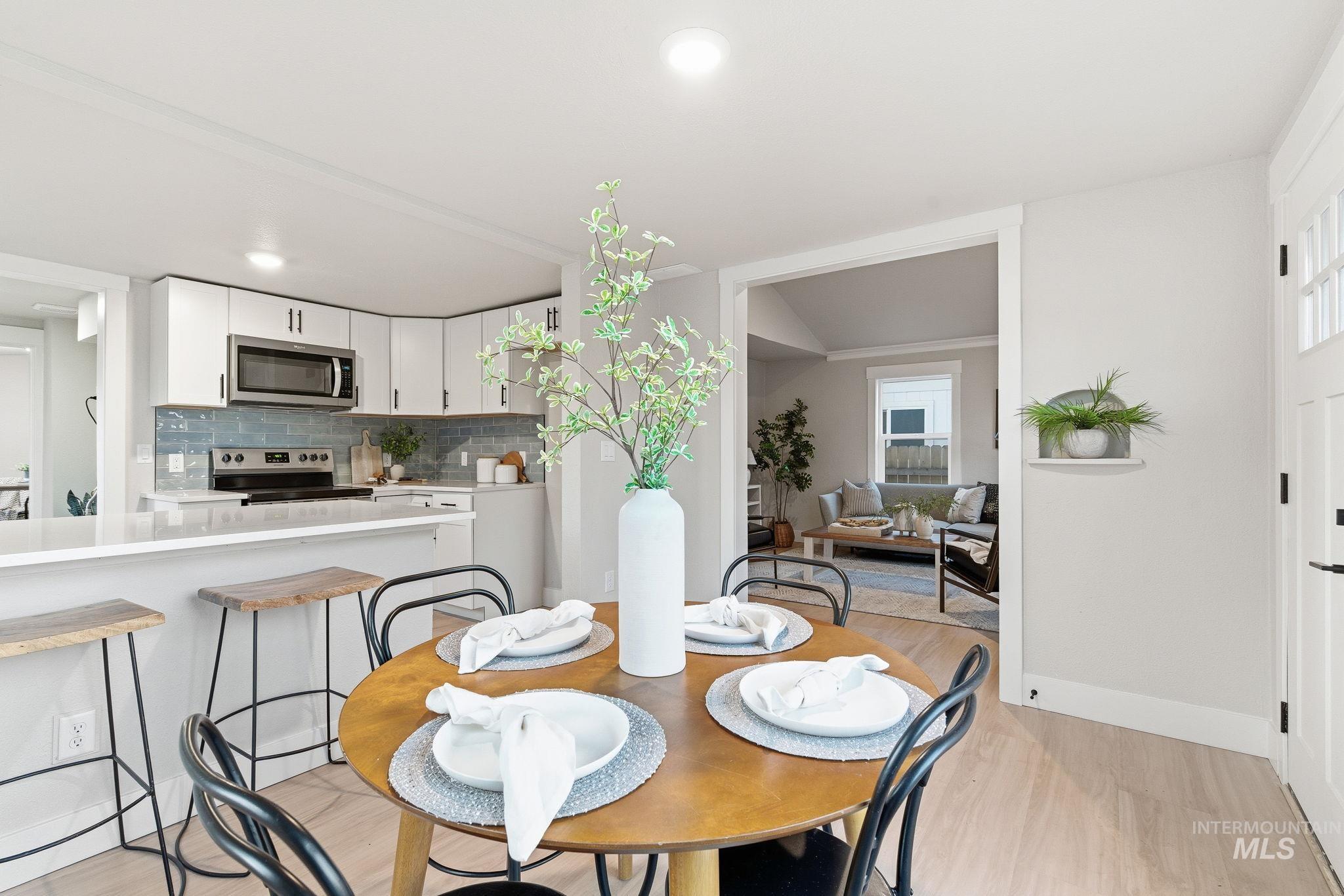Dining space featuring light wood-style flooring and recessed lighting