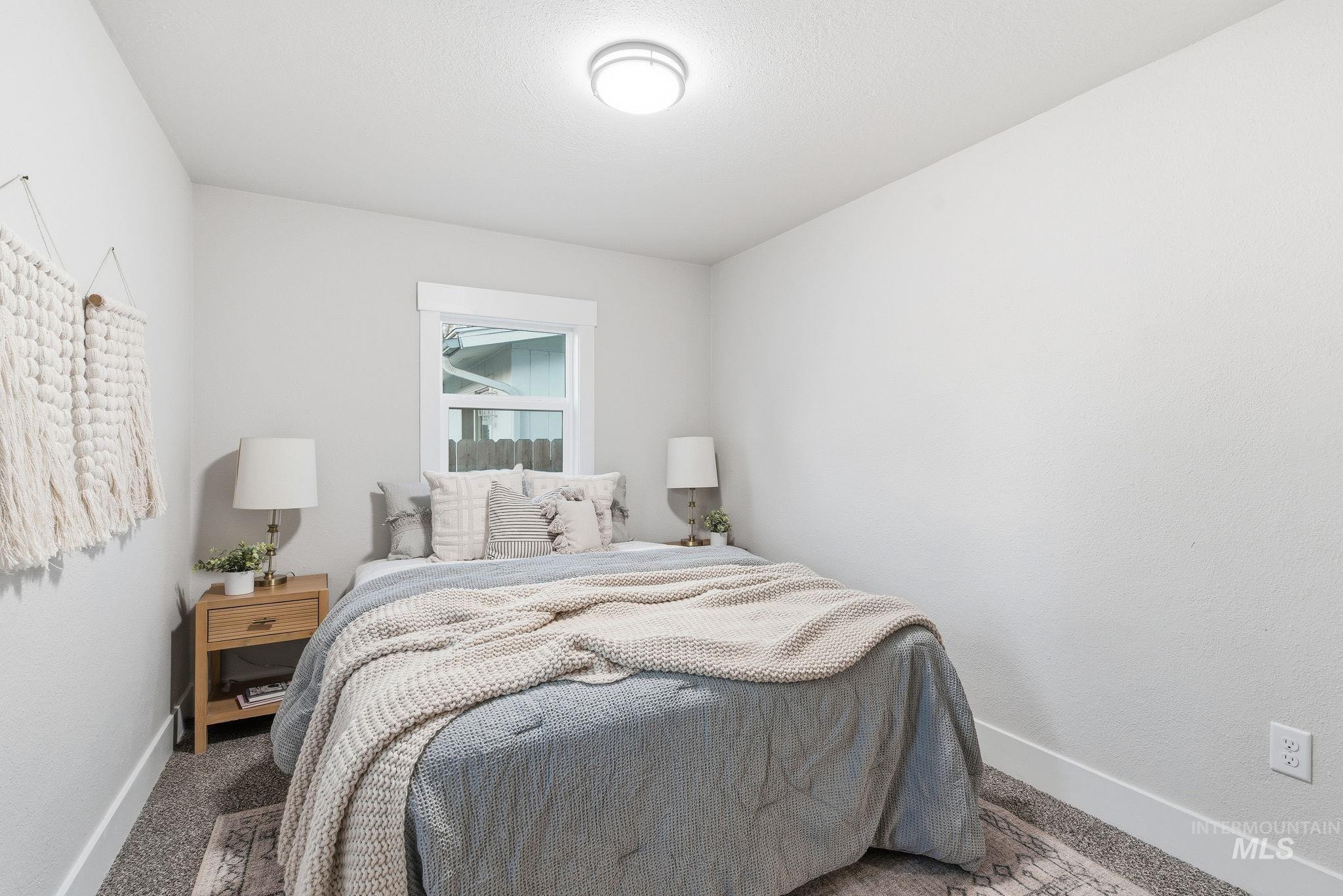 Carpeted bedroom featuring baseboards
