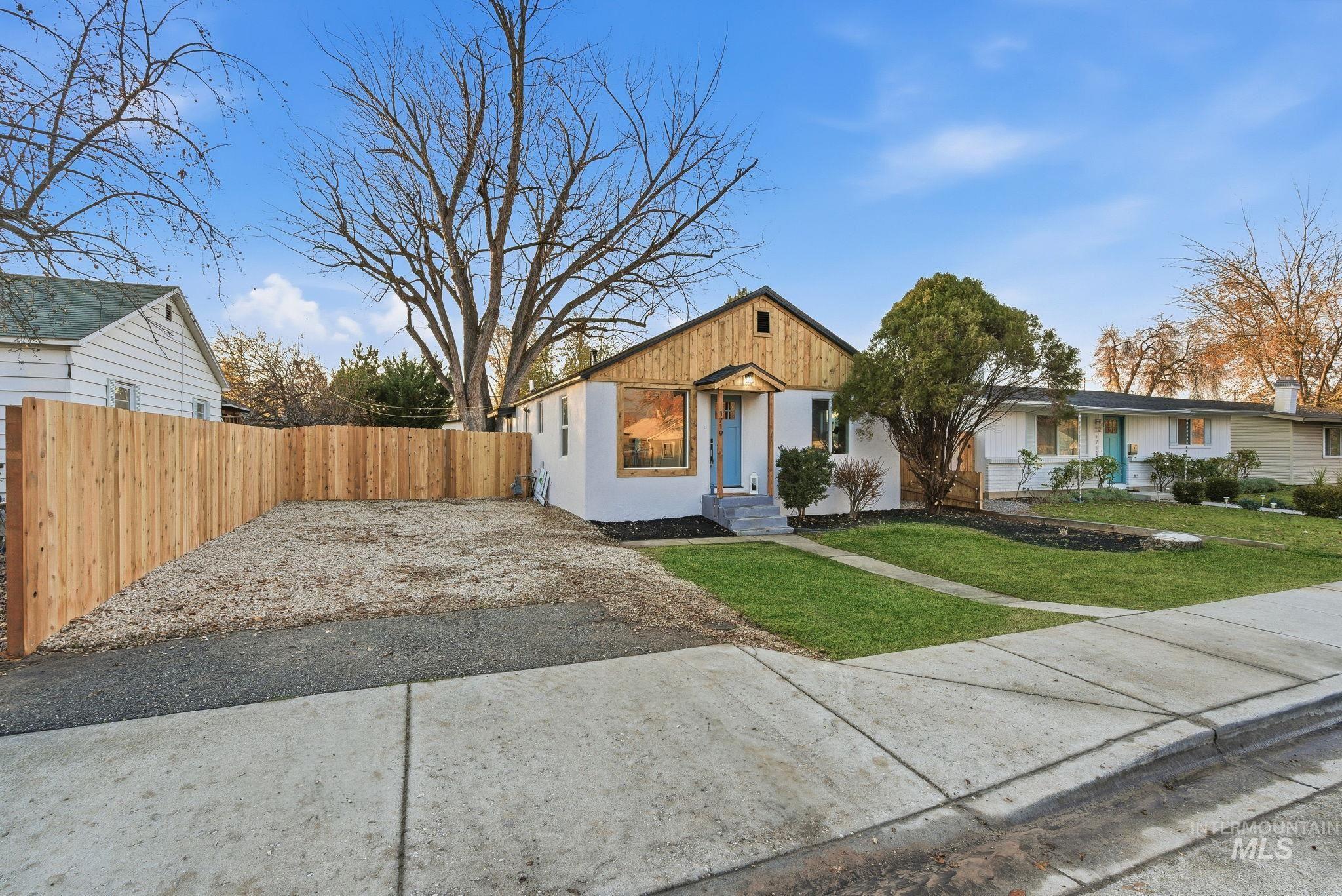 Bungalow-style home with stucco siding