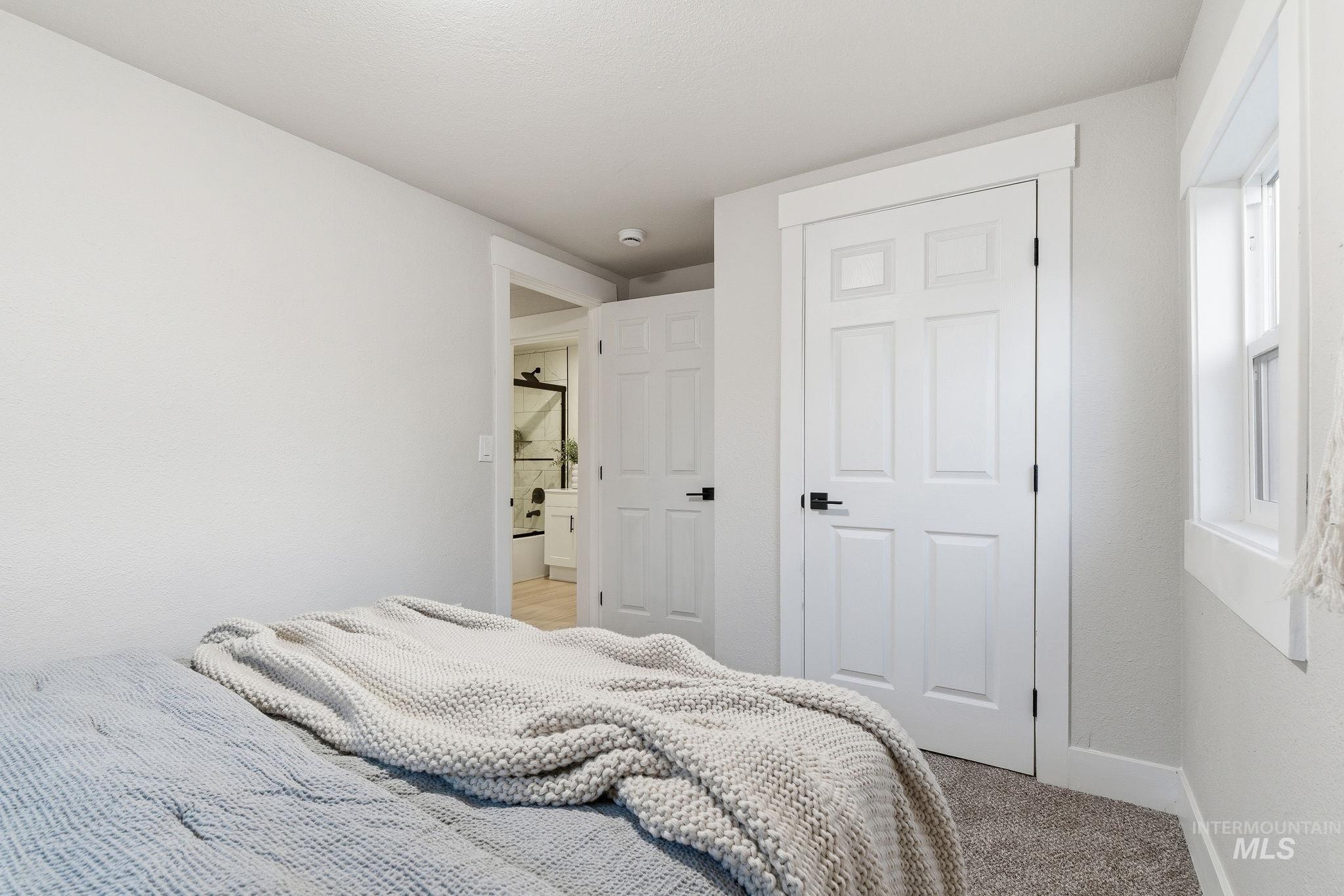 Bedroom with carpet floors and baseboards