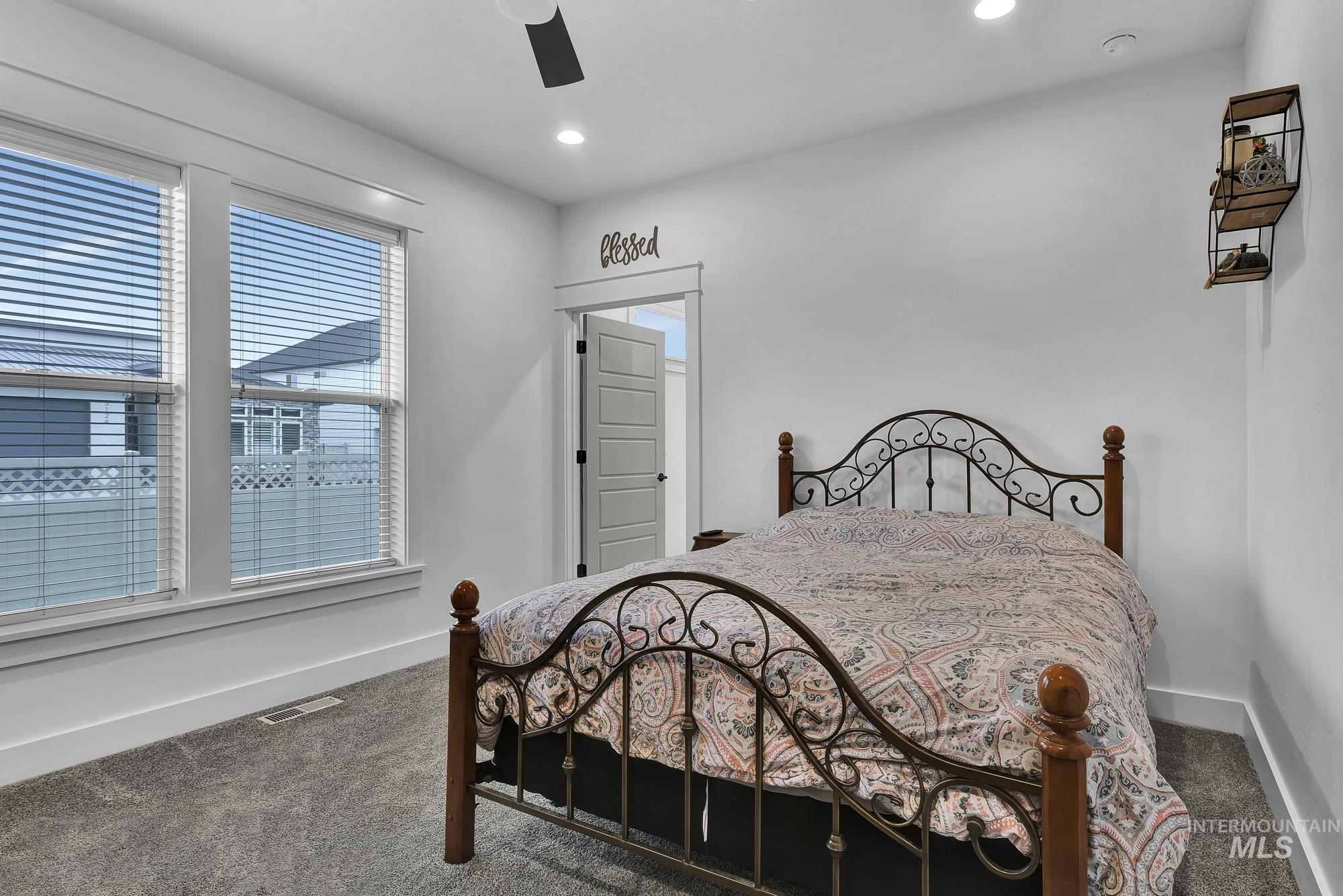 Bedroom with carpet, ceiling fan, and recessed lighting