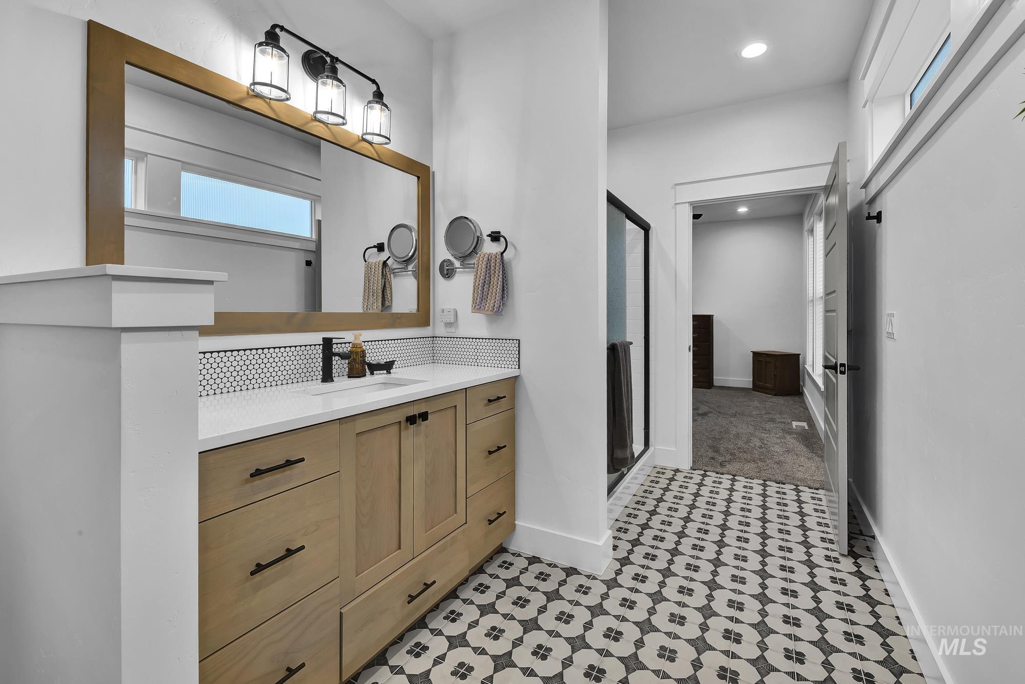 Full bath featuring vanity, a shower stall, and recessed lighting