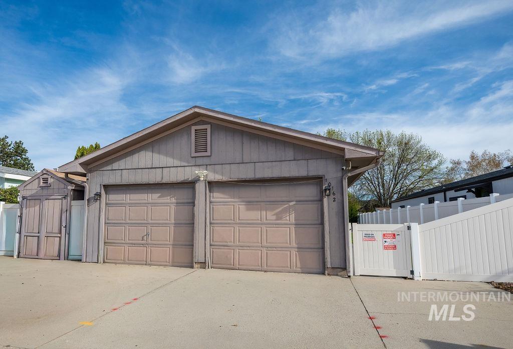 Garage featuring a gate and a storage unit