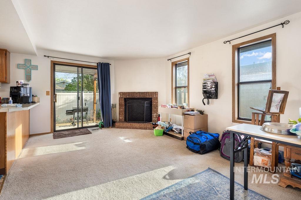 Living room featuring carpet flooring and a fireplace
