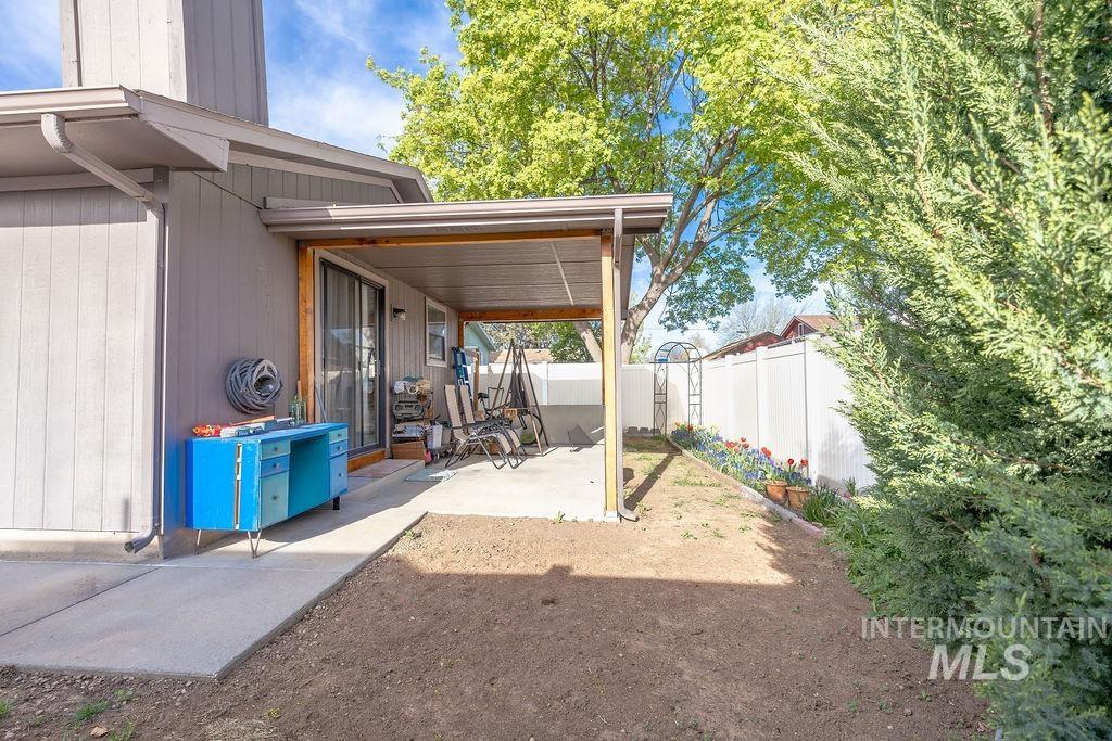 Fenced backyard with a patio