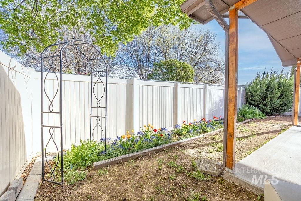 Fenced backyard featuring a garden and a patio