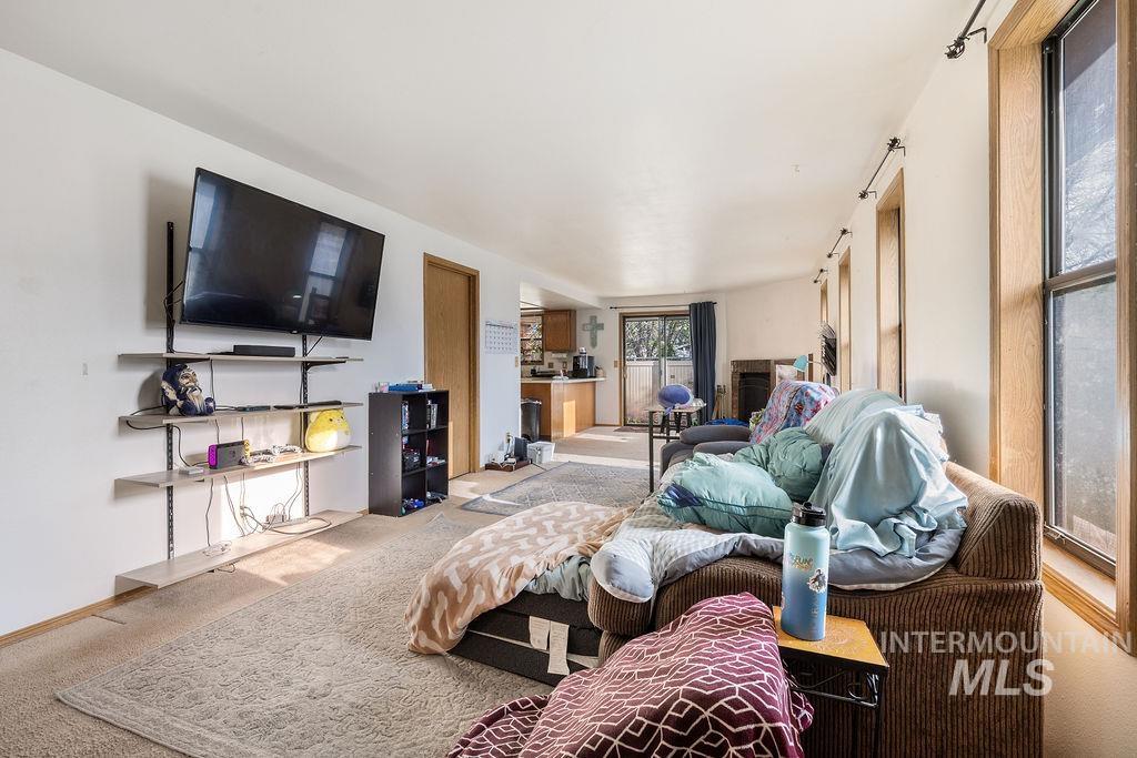 Carpeted living area with baseboards