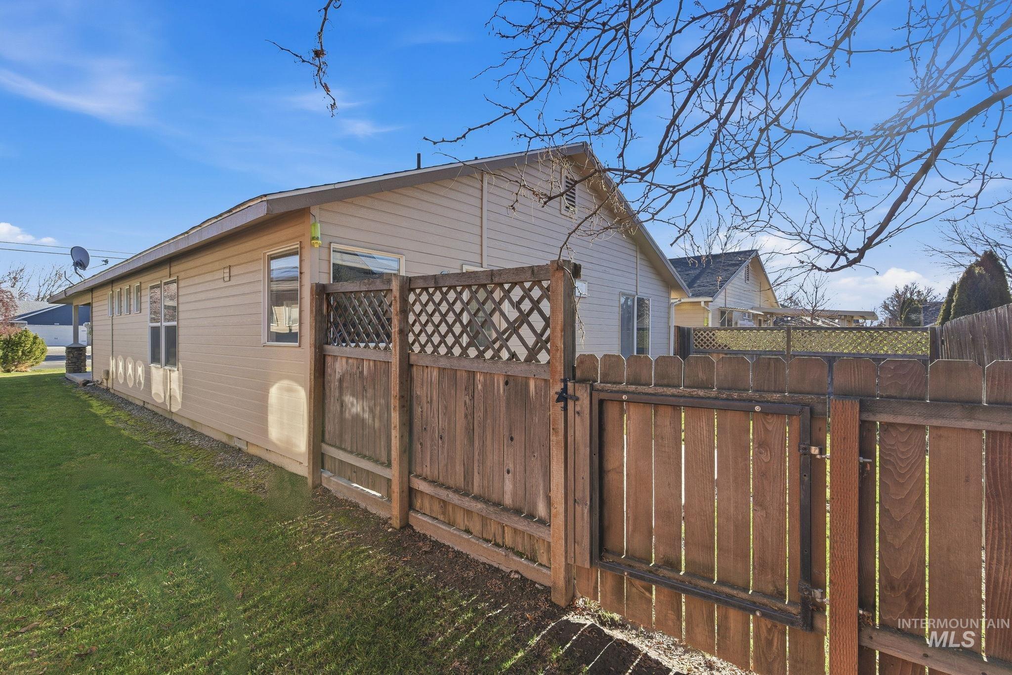 View of home's exterior with a gate and a central air condition unit