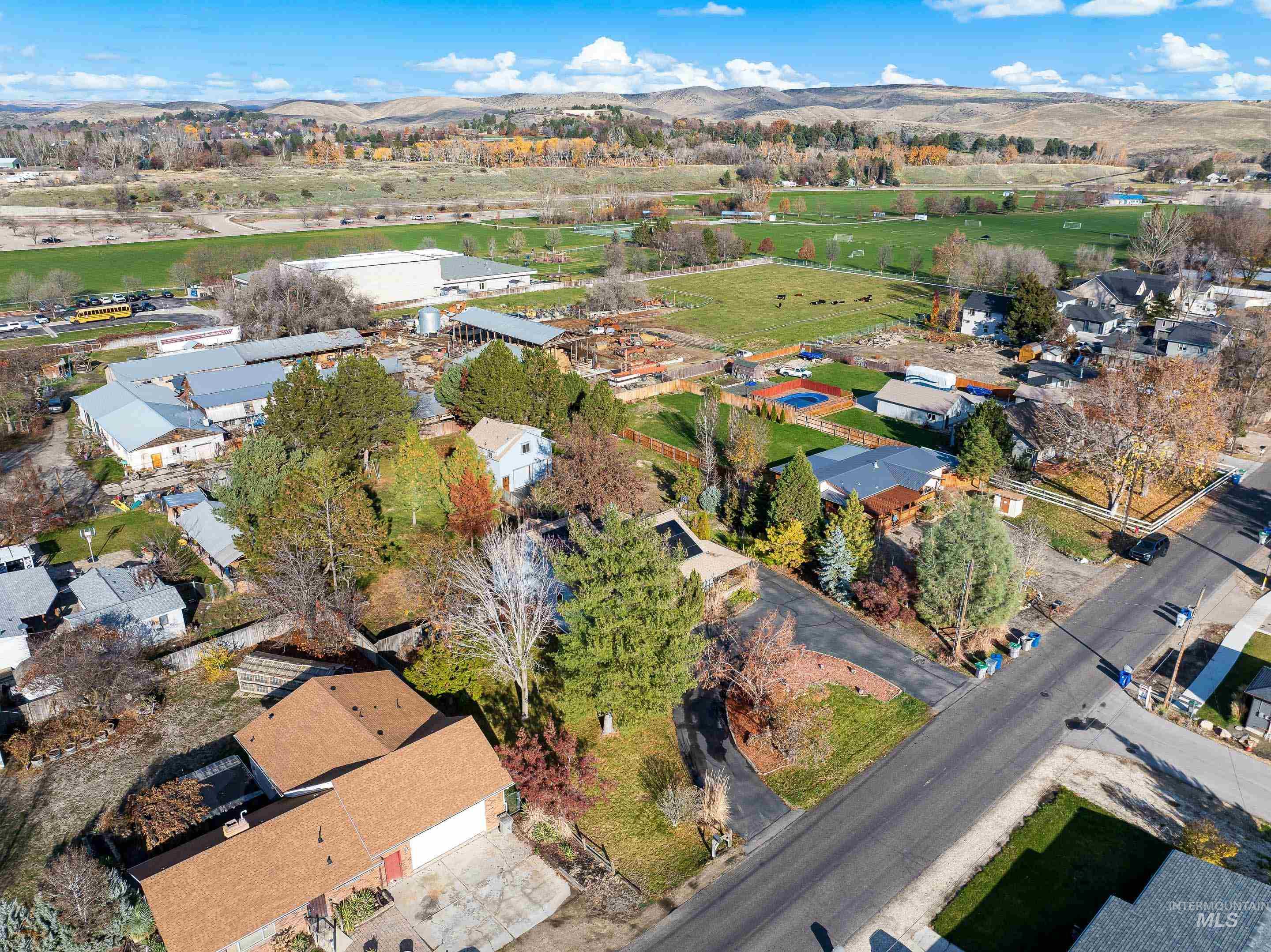 Aerial view of property's location featuring a mountainous background and nearby suburban area