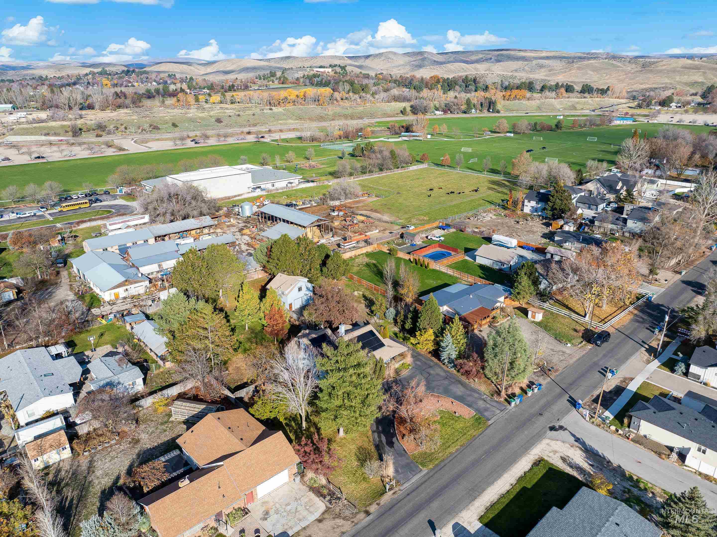 Aerial view of property's location with nearby suburban area and mountains