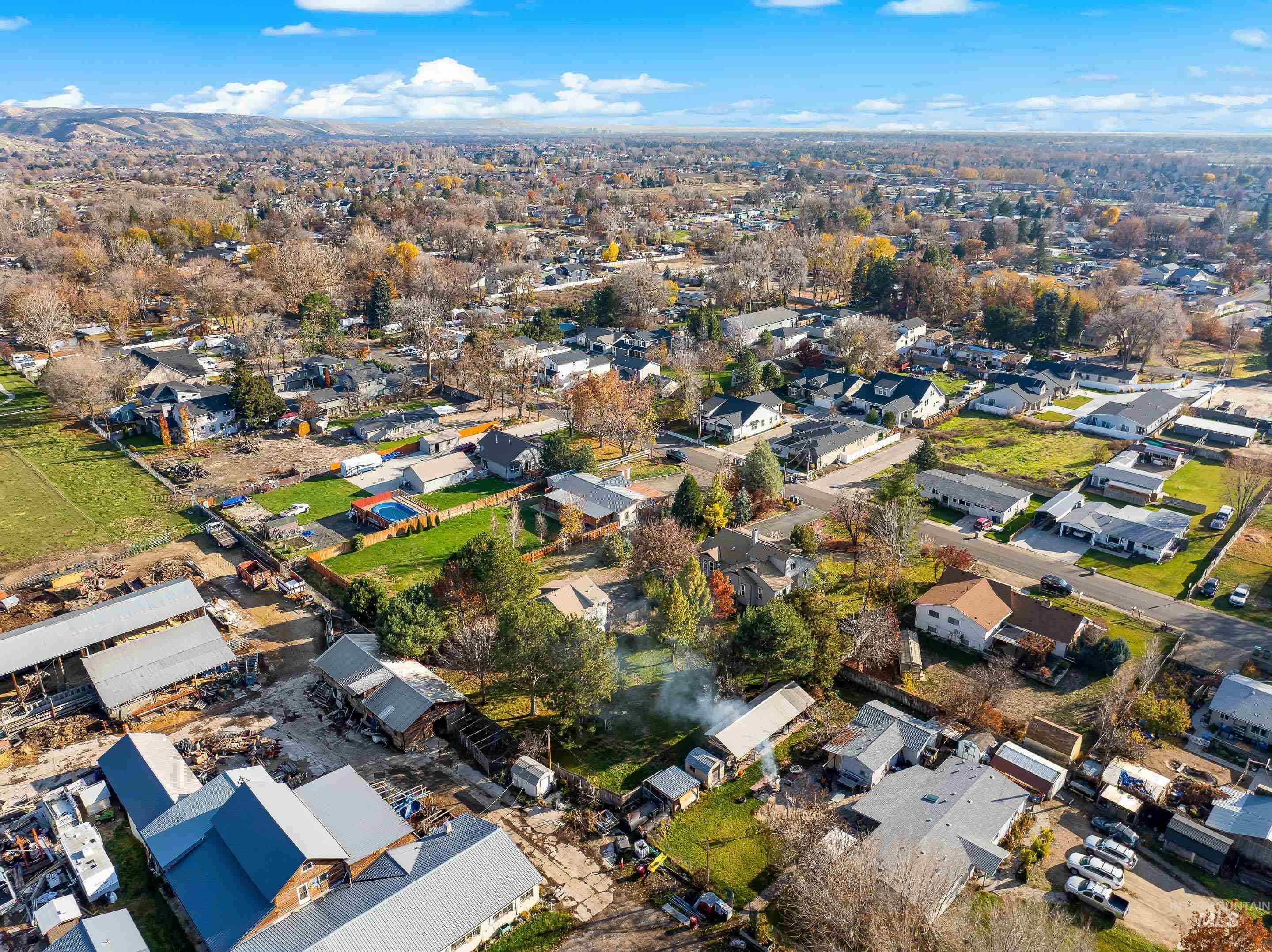 Aerial view of property's location with nearby suburban area
