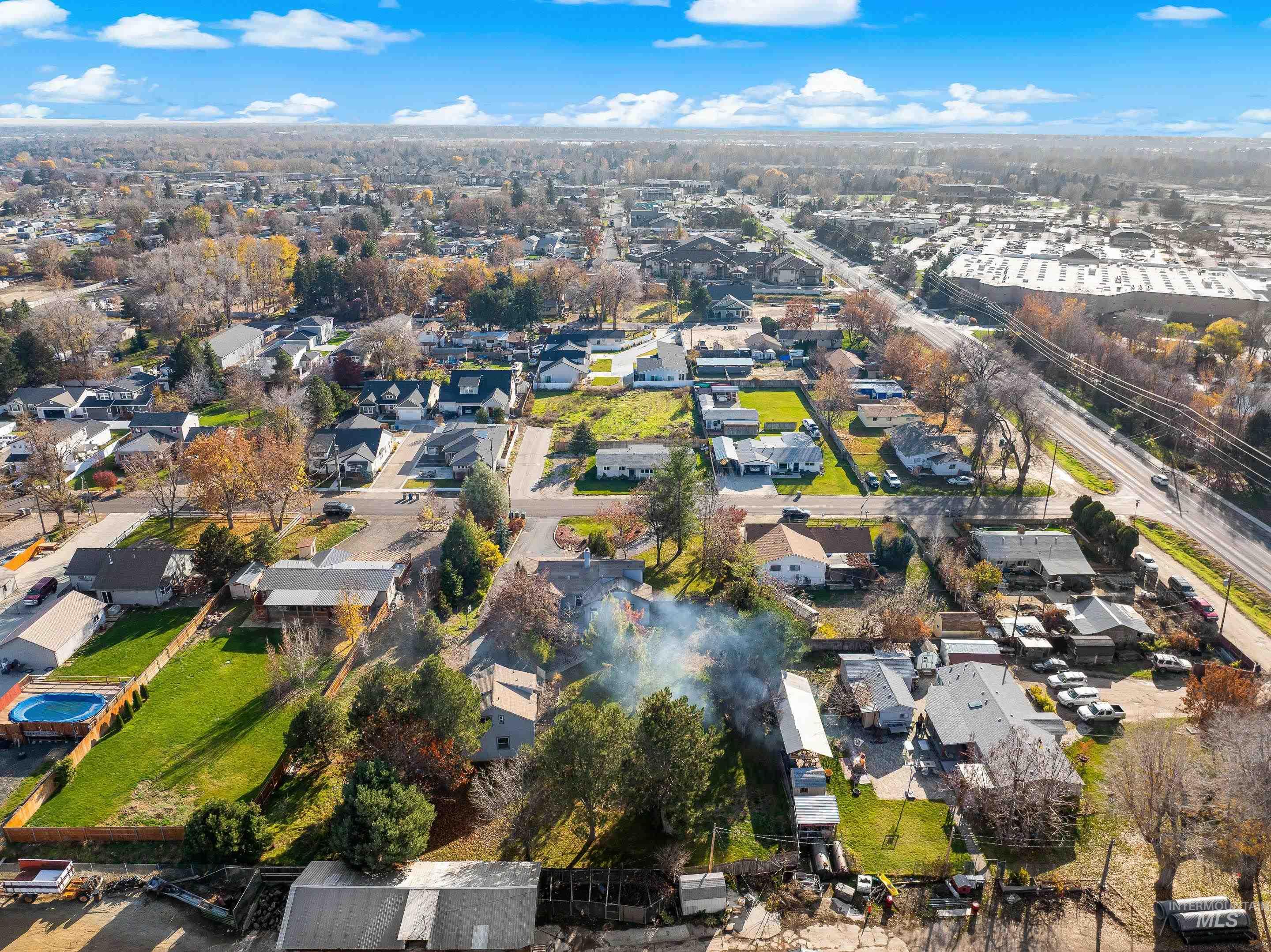 Aerial view of property's location with nearby suburban area