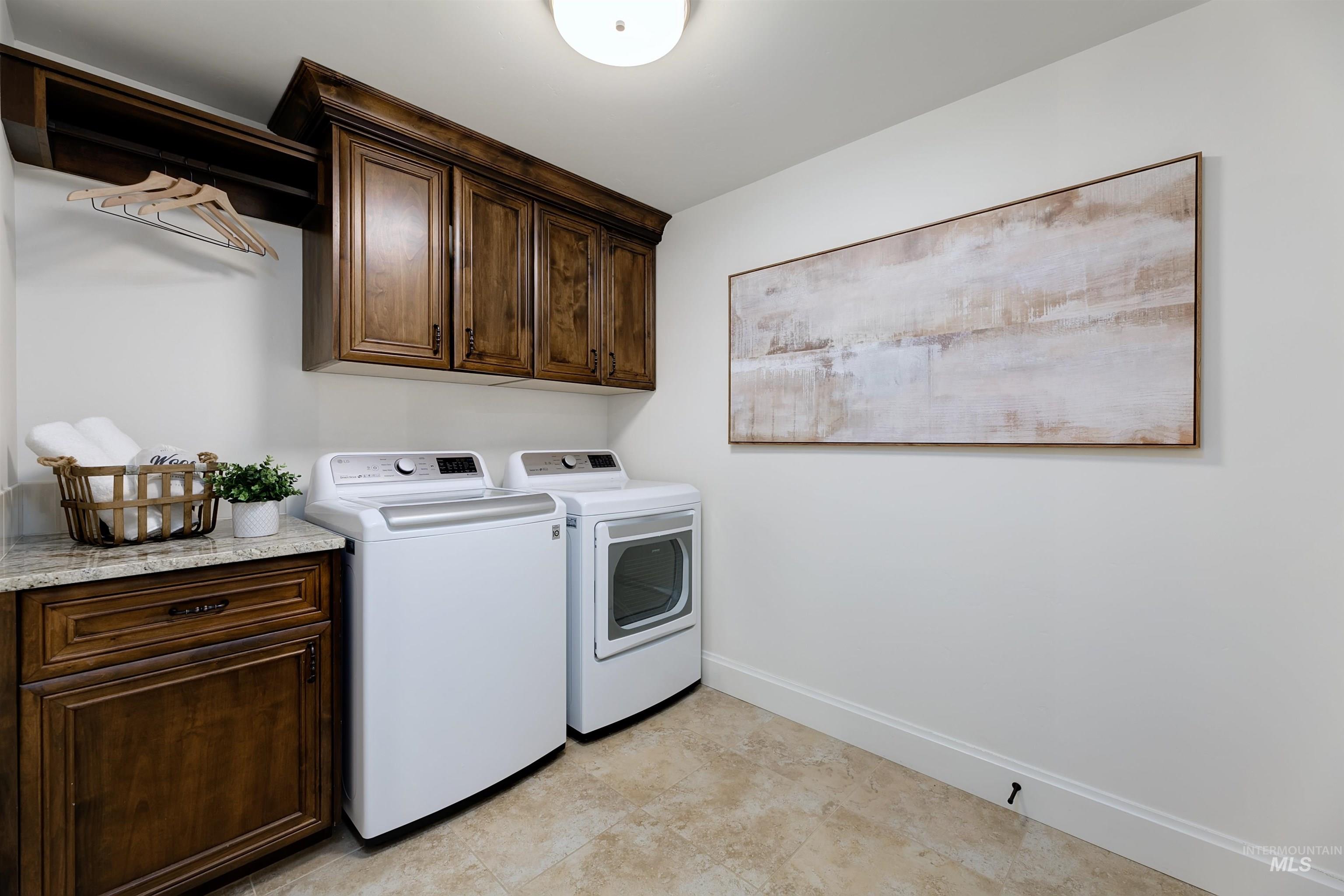 Laundry room with cabinet space and independent washer and dryer